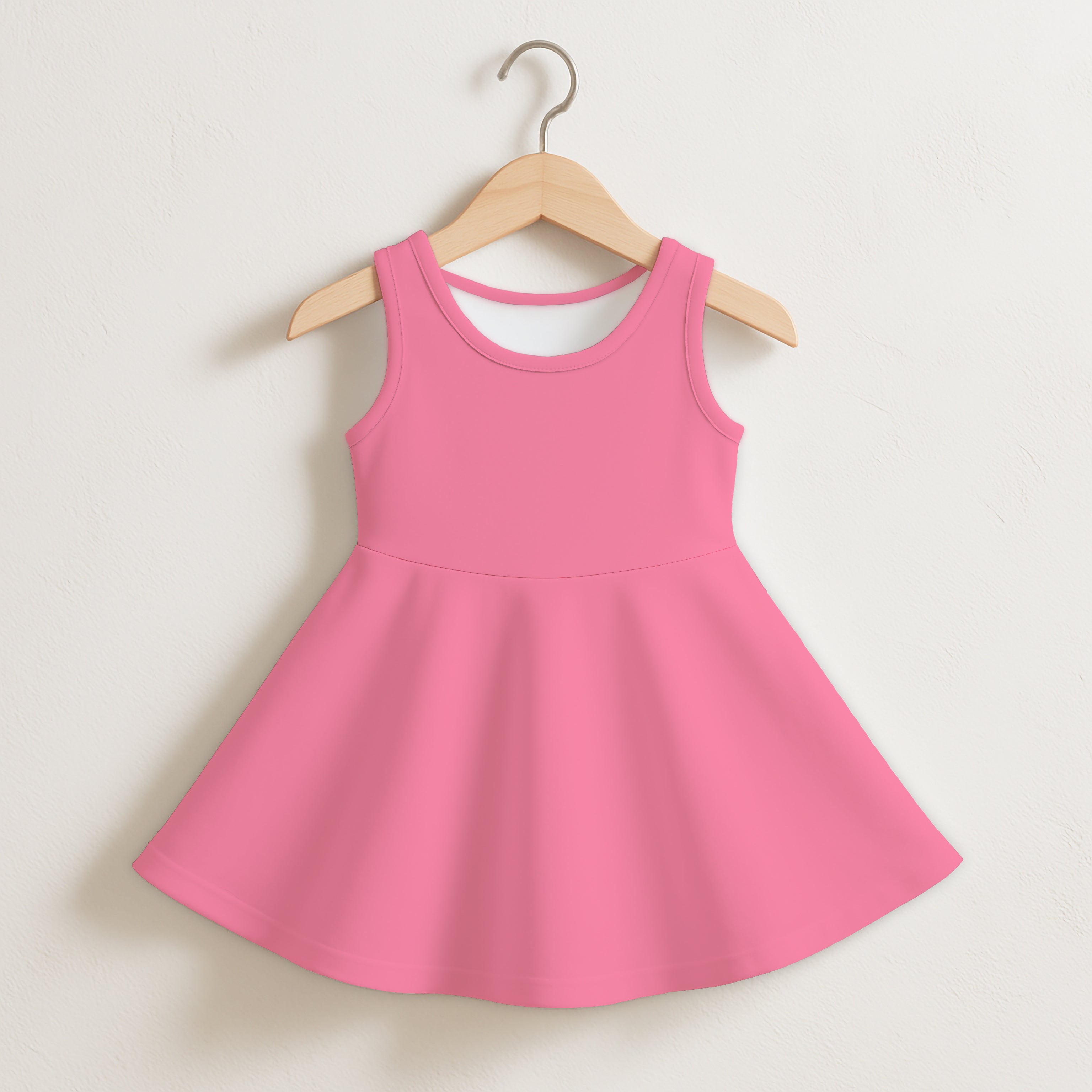 A vibrant pink sleeveless toddler dress with a flared skirt and rounded neckline hanging on a wooden hanger