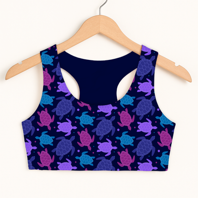 Girls purple sea turtle sports bra in navy blue with a vibrant sea turtle pattern, quick drying and double layered for comfort