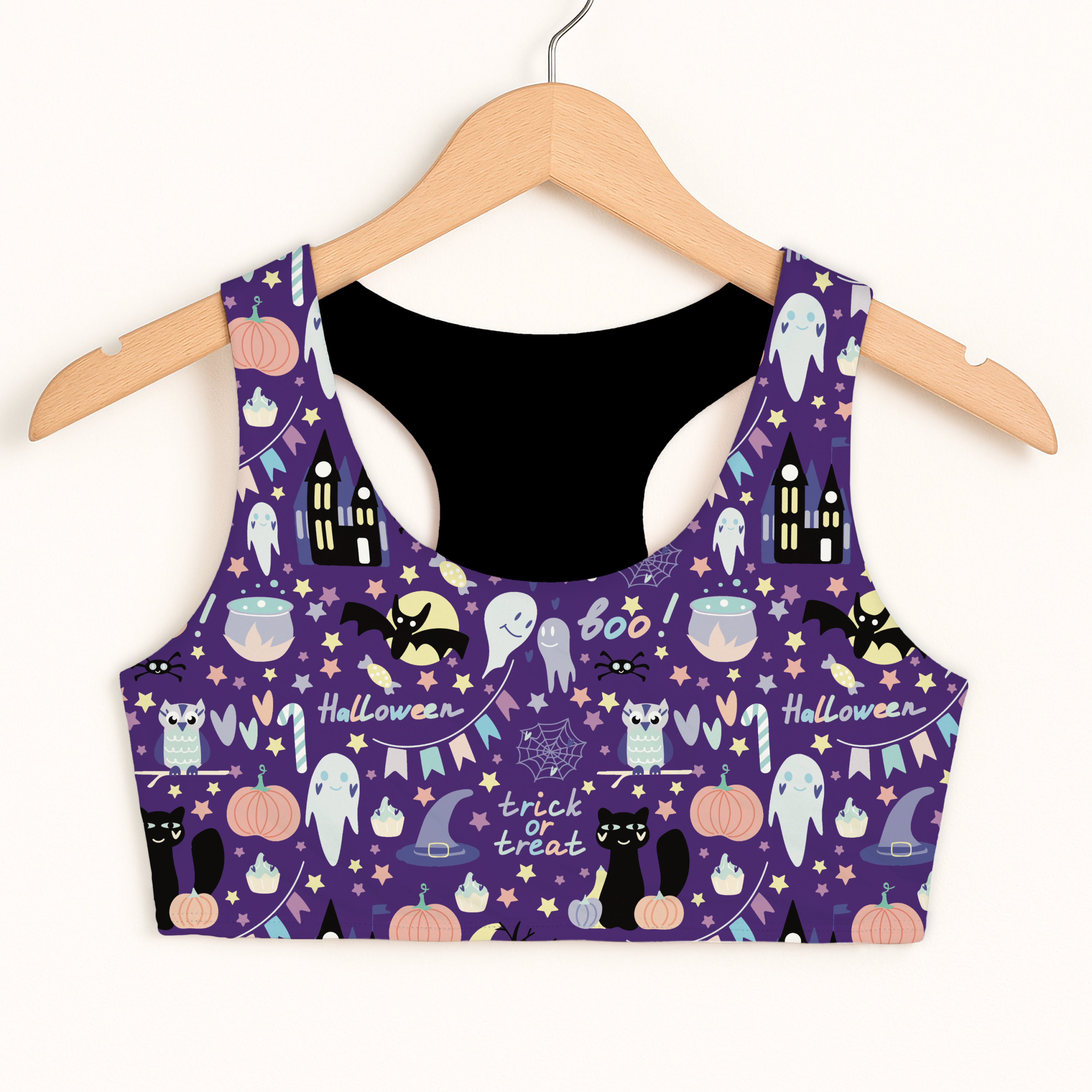Girls spooky halloween sports bra purple crop top with black lining featuring ghosts bats pumpkins and owls design