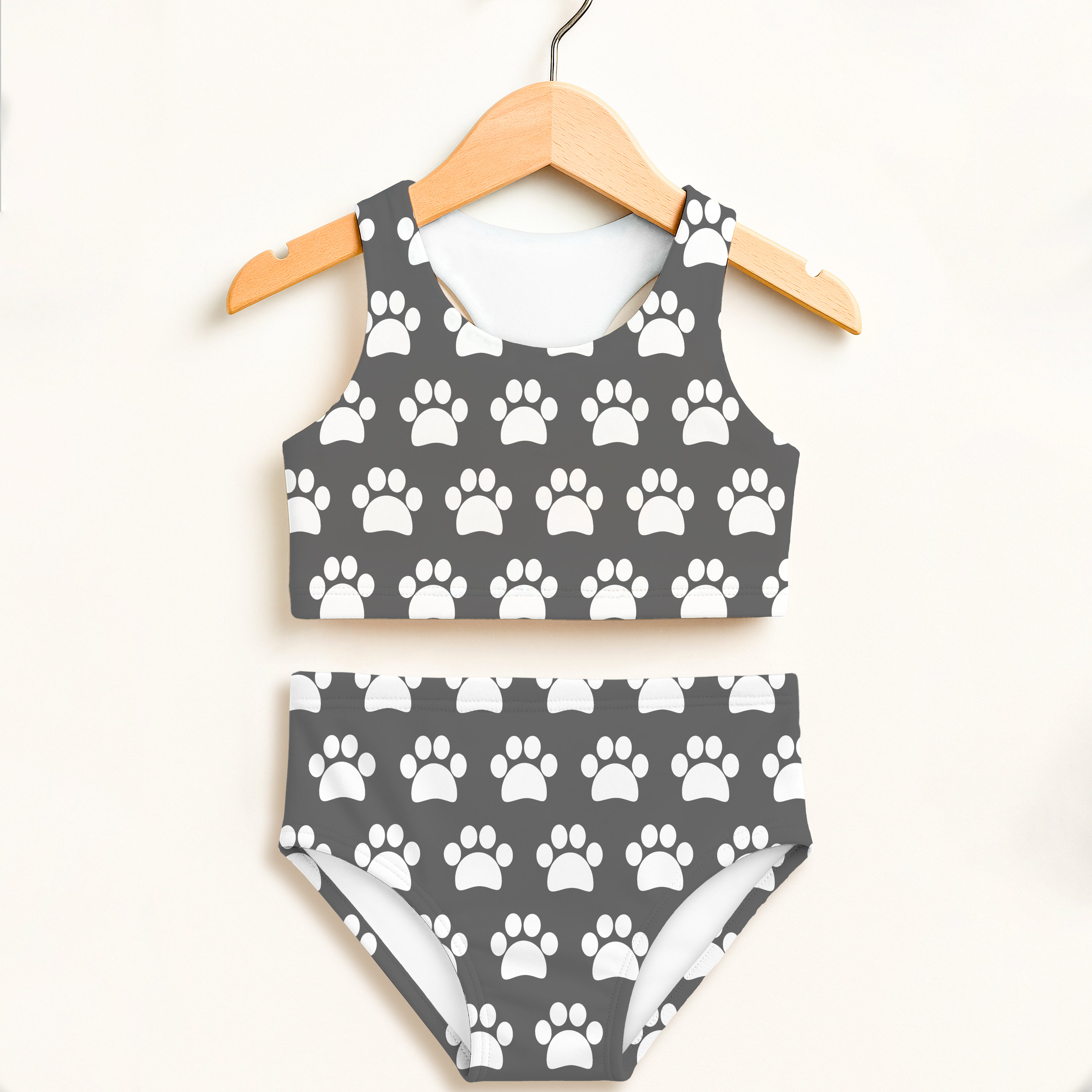 Girls gray two-piece swimsuit with white paw print pattern featuring halter top and high-waisted bottoms with upf 50+ protection