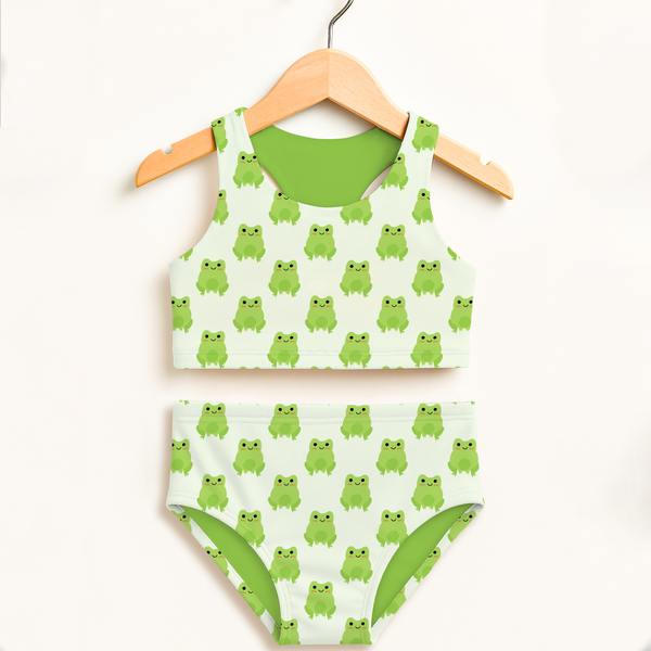 Girls green frog two piece swimsuit with white base and cheerful frog pattern featuring lime green lining and upf 50+ protection