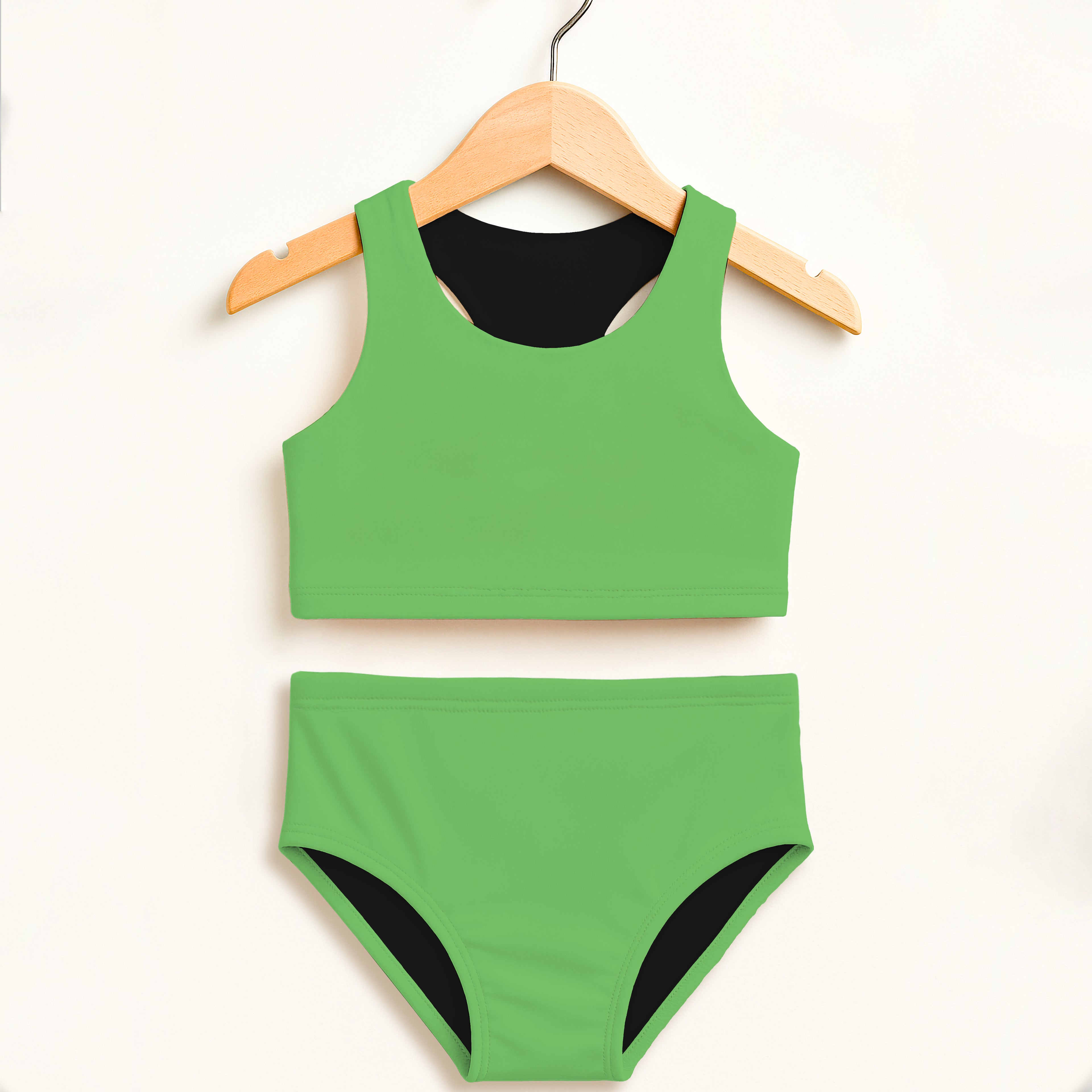 Back view of girls green two piece swimsuit with black lining high waisted double layered upf 50 plus protection