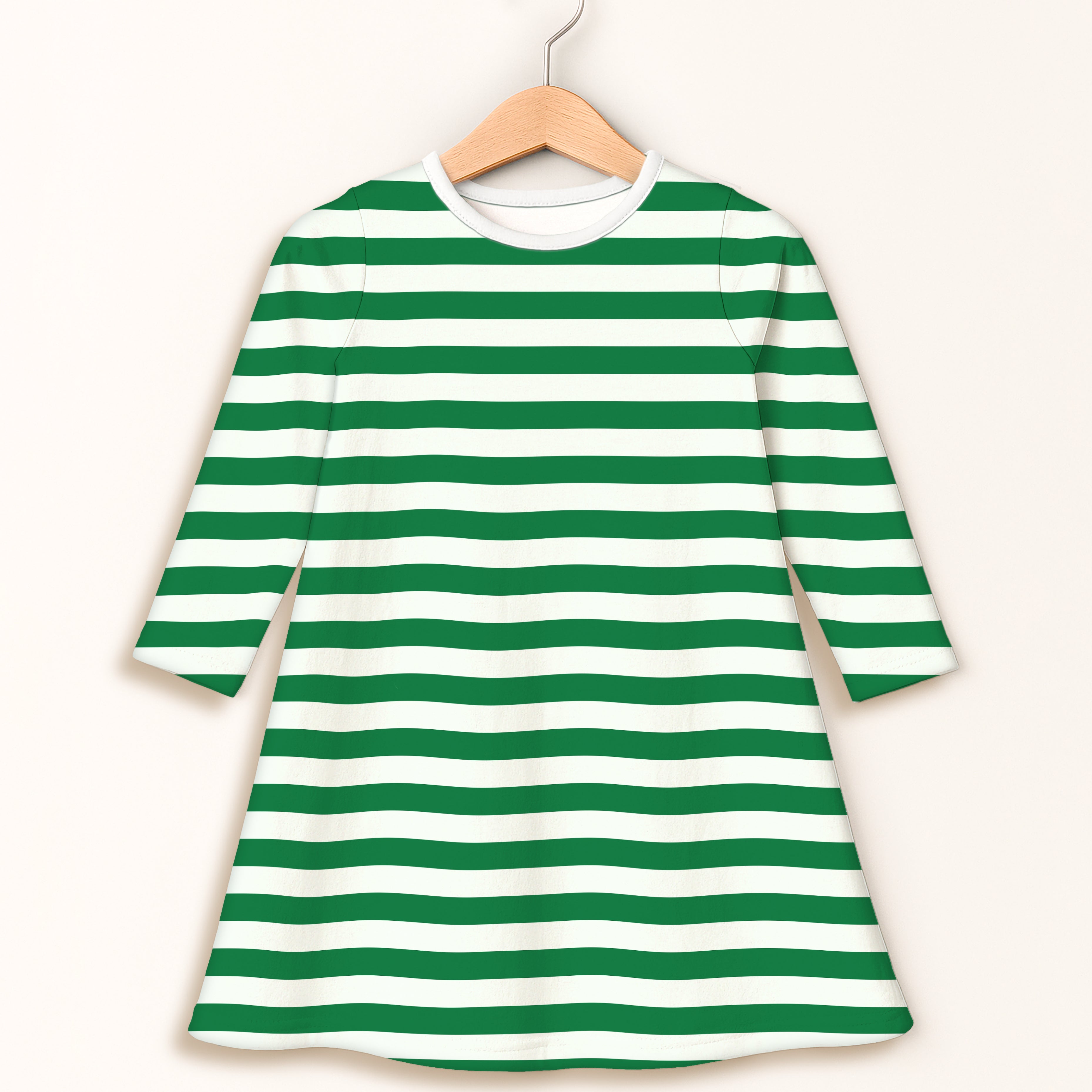 Girls green and white striped long sleeve dress with three quarter sleeves hanging on a wooden hanger