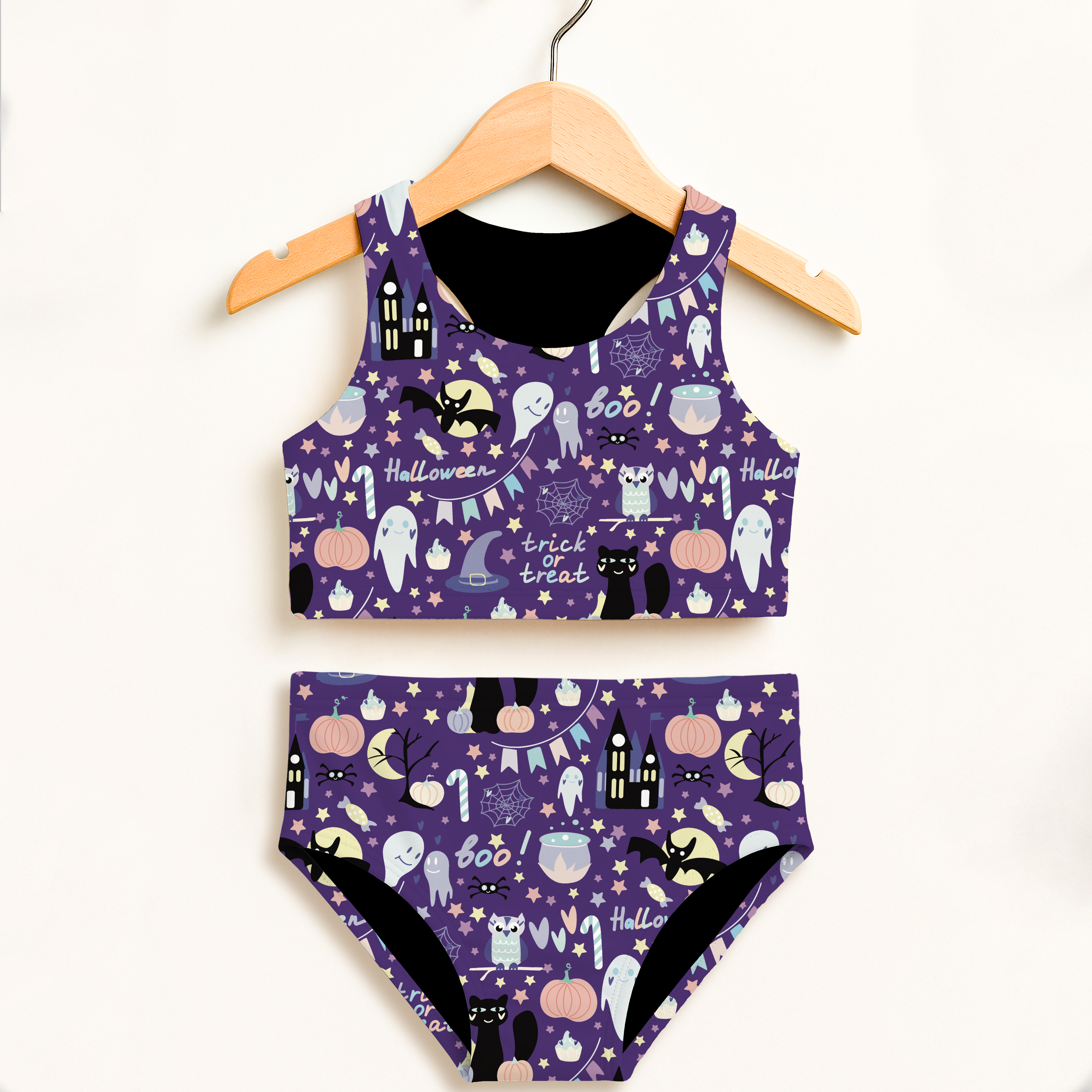 Girls spooky halloween two piece swimsuit in purple with black trim featuring ghosts pumpkins bats and trick or treat text