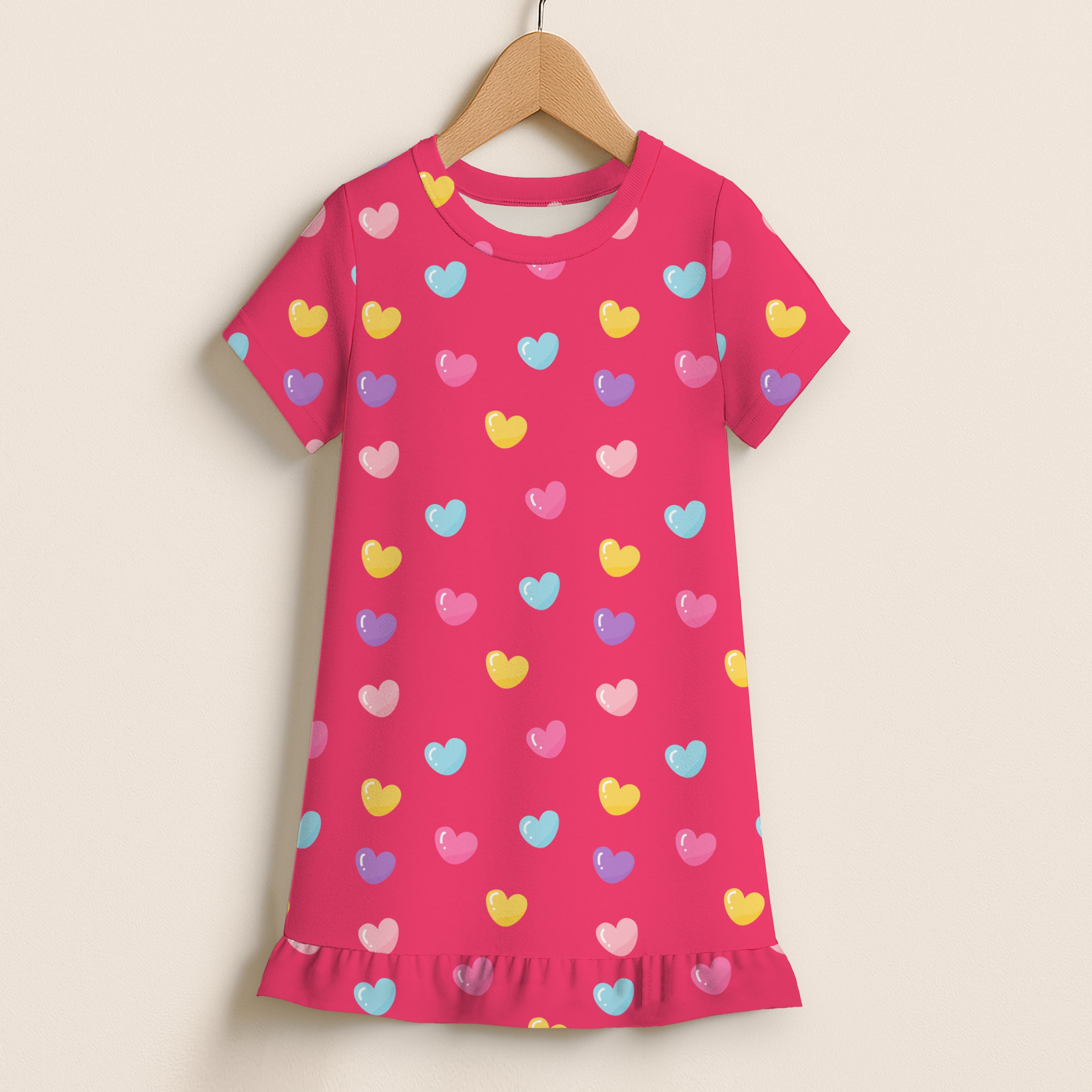 A vibrant pink girls short sleeve nightgown with colorful heart print and ruffle hem perfect for sleepwear