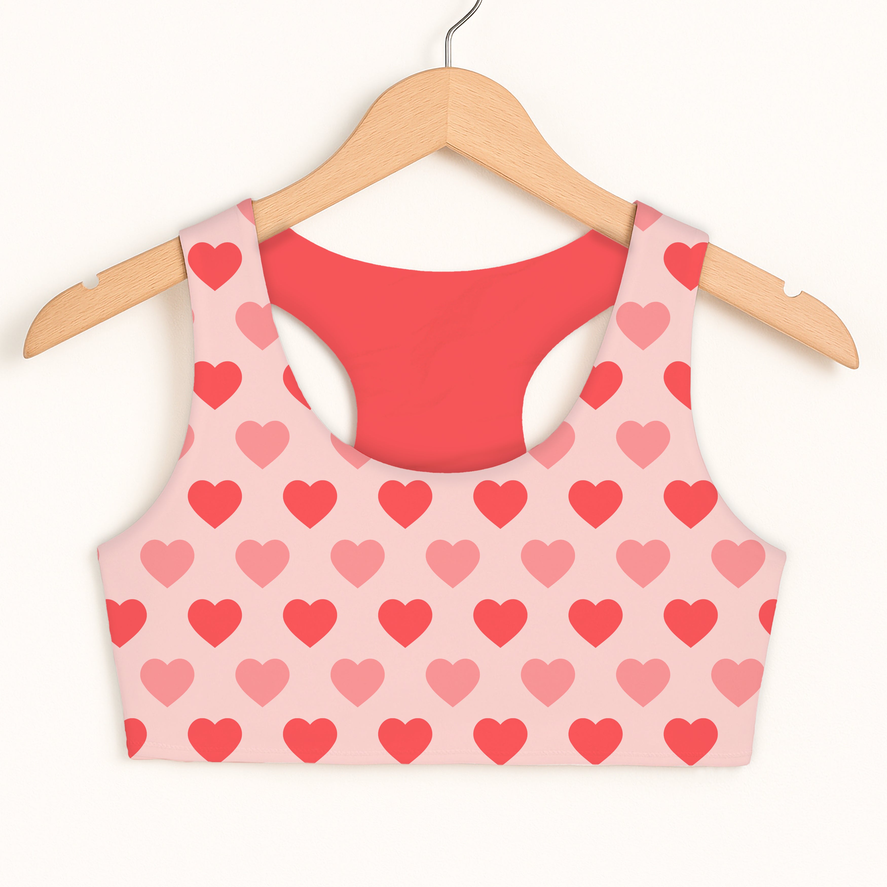 Girls blush pink heart sports bra with red interior lining featuring quick drying and double layered comfort design