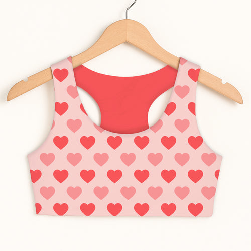 Girls blush pink heart sports bra with red interior lining featuring quick drying and double layered comfort design