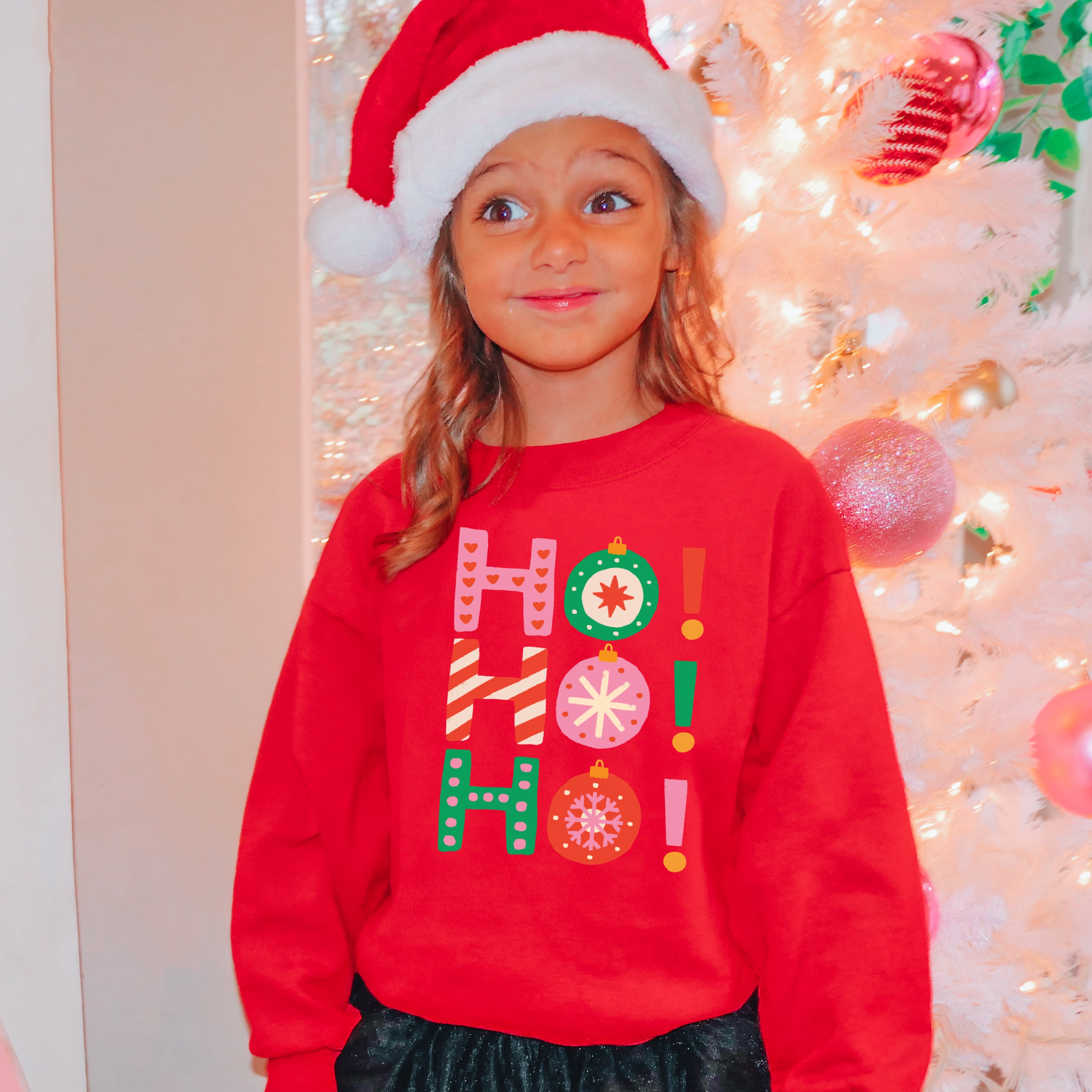 Red kids holiday sweatshirt with ho ho printed in colorful letters and ornament decorations for festive wear