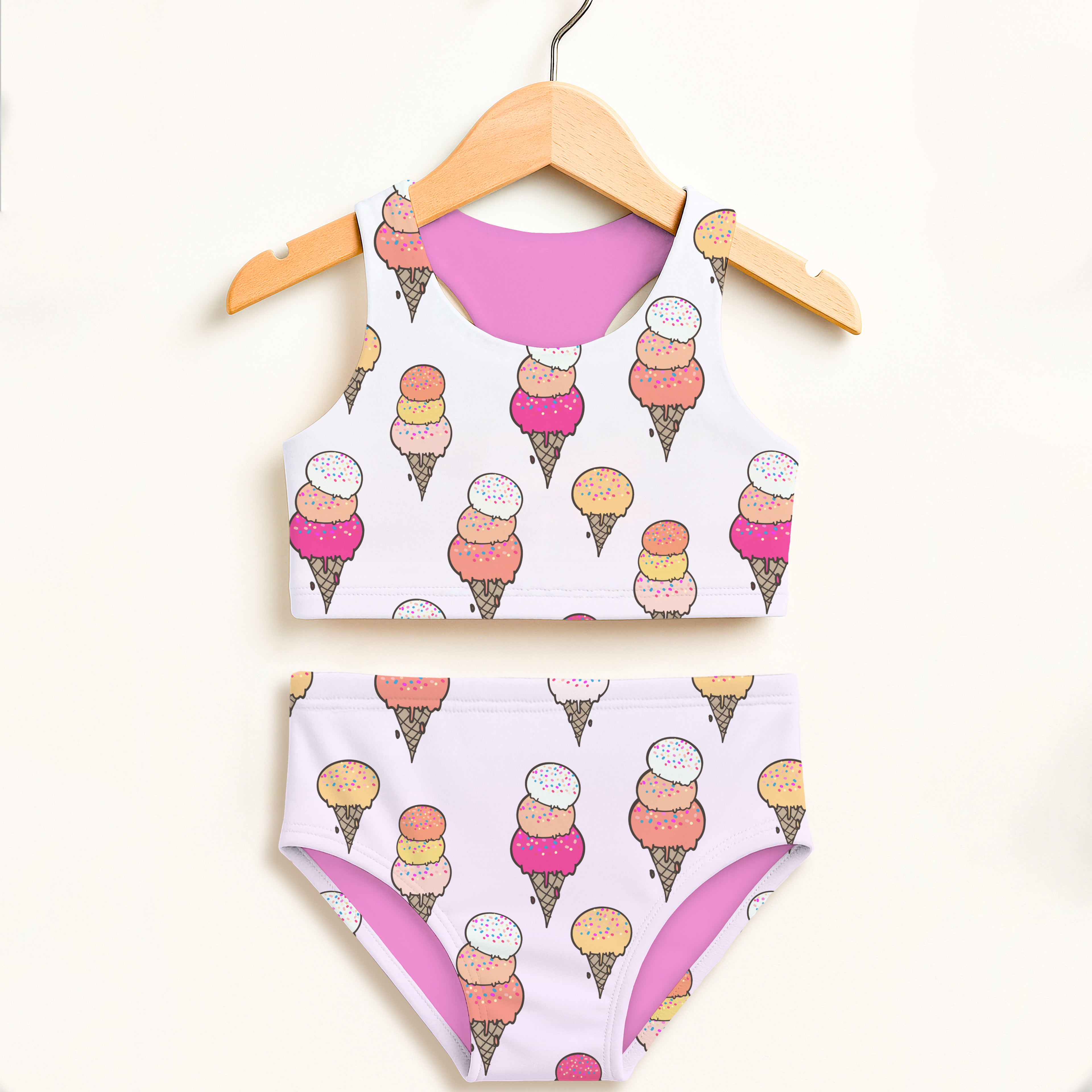 Girls colorful ice cream two piece swimsuit with white and pink cone pattern halter neckline and UPF 50+ protection