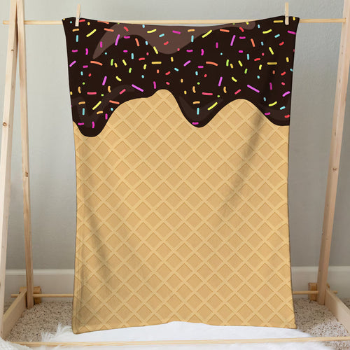 A cozy beige chocolate ice cream cone blanket with colorful sprinkles and a waffle texture design