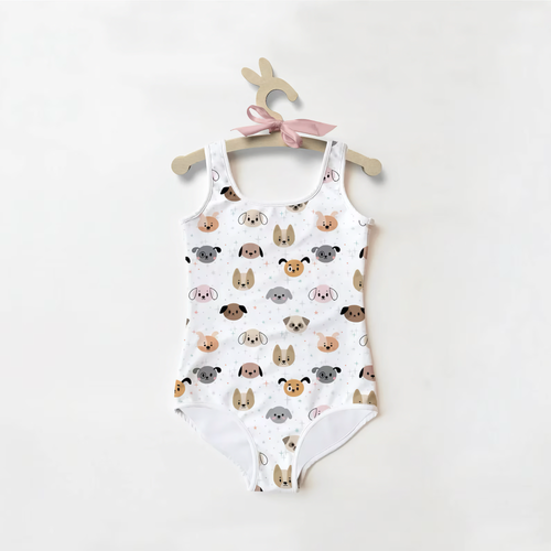 Girl's white one-piece swimsuit with cute pastel dog faces pattern, hung on animal-shaped hanger