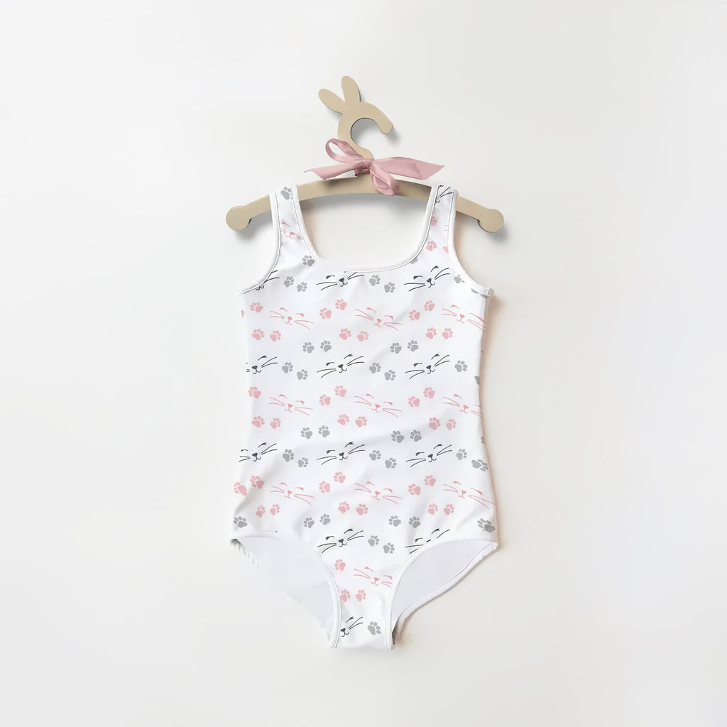 Girls paw print cat buttery soft white swimsuit with pink and gray cat faces and paw prints on wooden bunny hanger