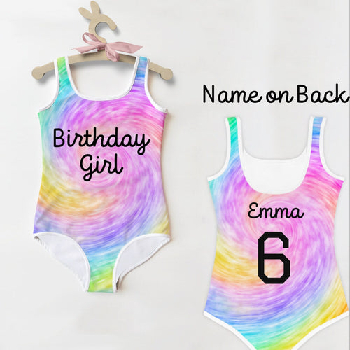 Back side of girls custom age and name faux rainbow tie dye one-piece swimsuit with white trim and personalized number