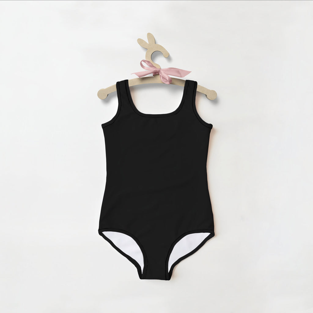 Girls buttery soft black one-piece swimsuit with white lining and upf 50 plus hanging on wooden bunny hanger