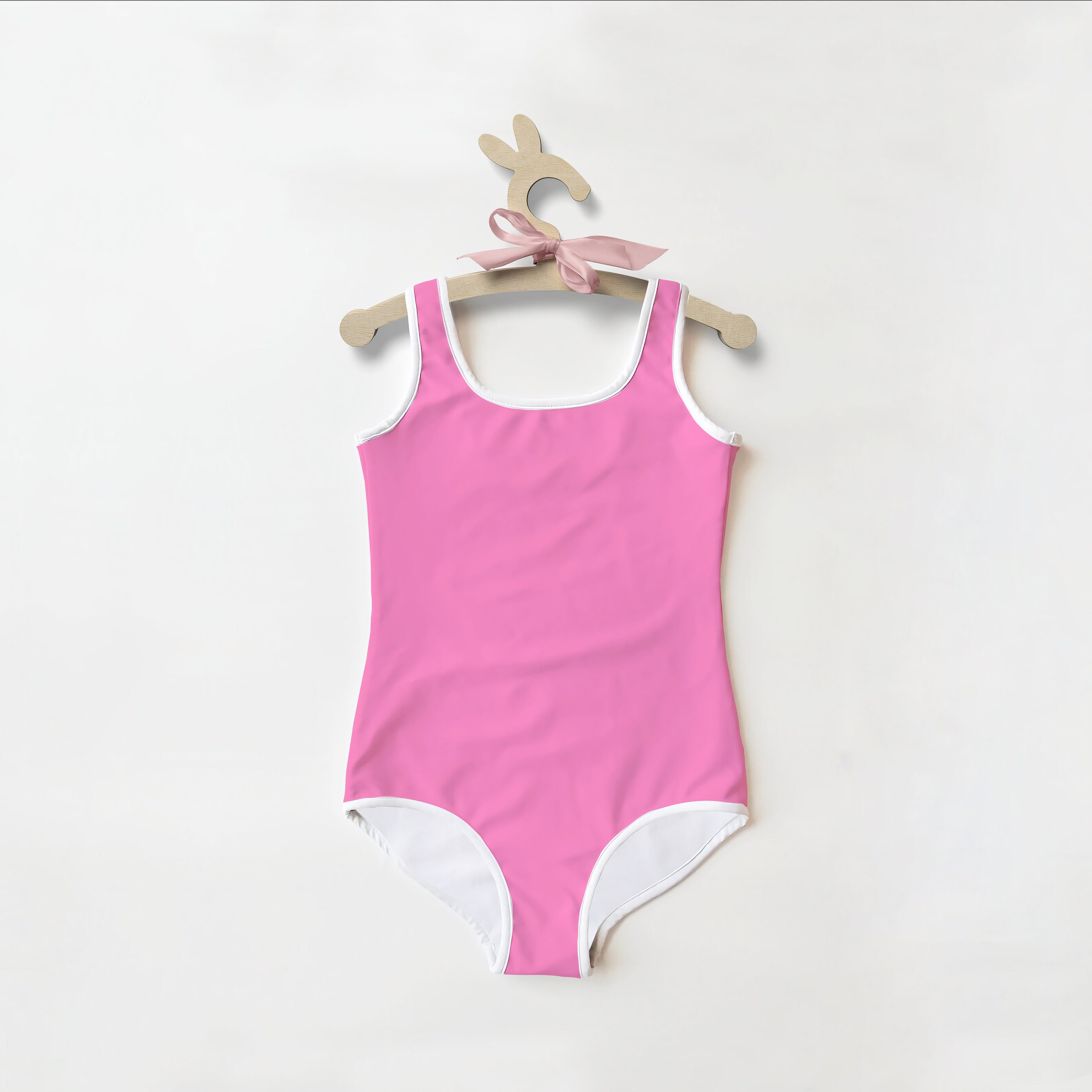 Girls buttery soft pink one-piece swimsuit with white trim and UPF 50 plus for sun protection
