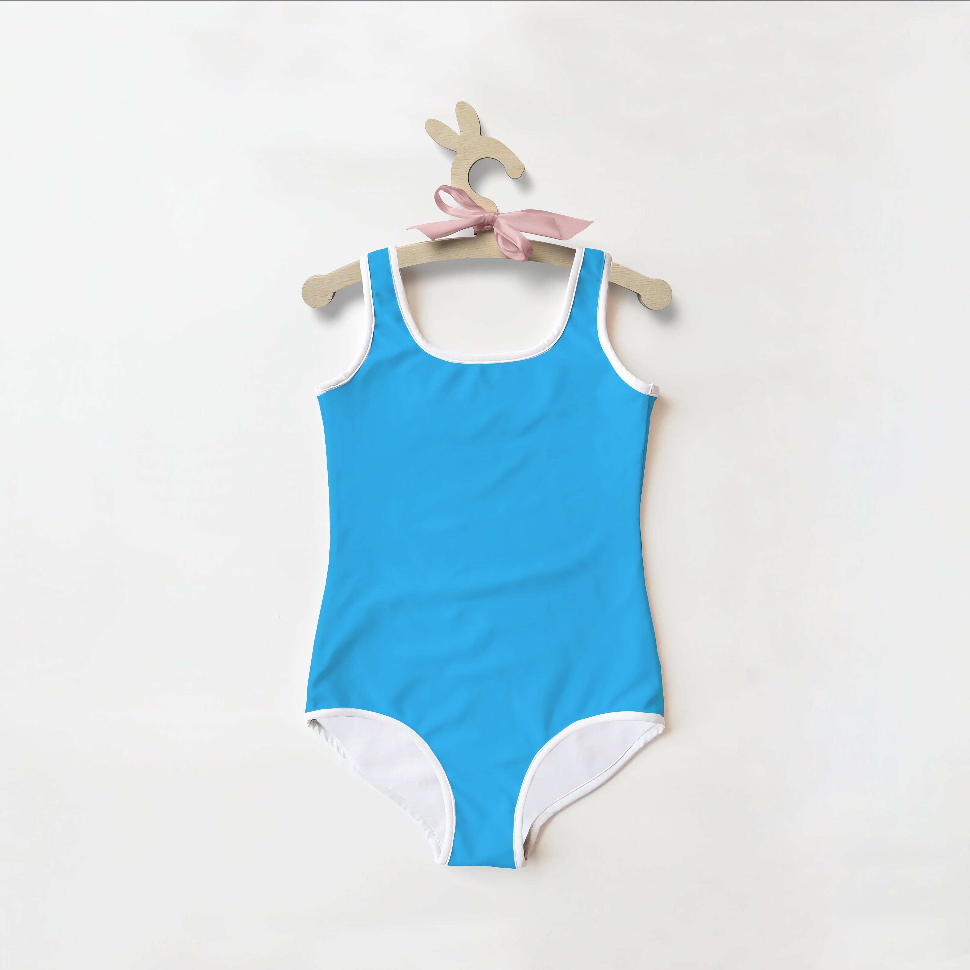 Girls buttery soft bright blue one-piece swimsuit with white trim and pink ribbon for UPF 50+ sun protection