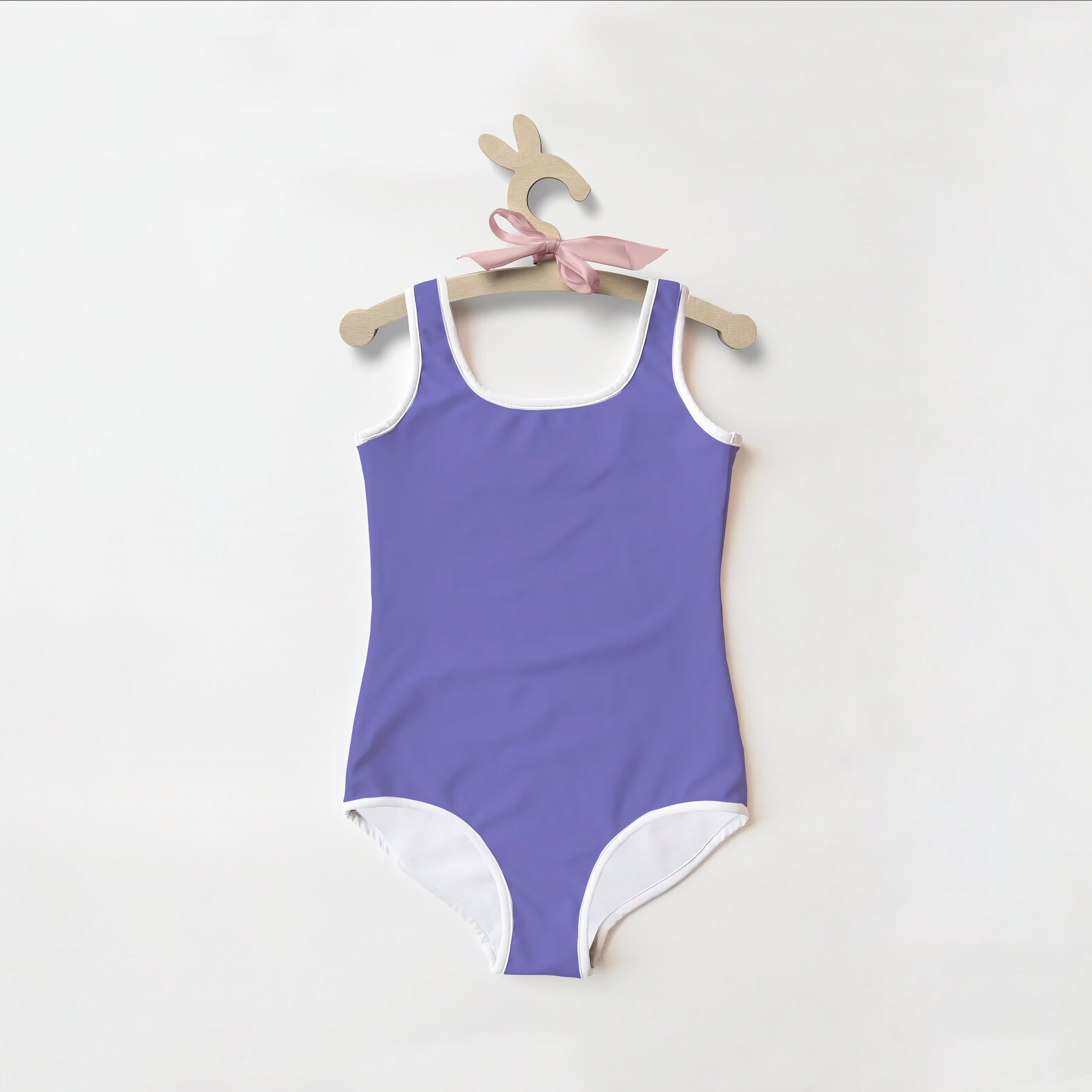 Girls buttery soft purple one-piece swimsuit with white trim and pink ribbon with upf 50 sun protection