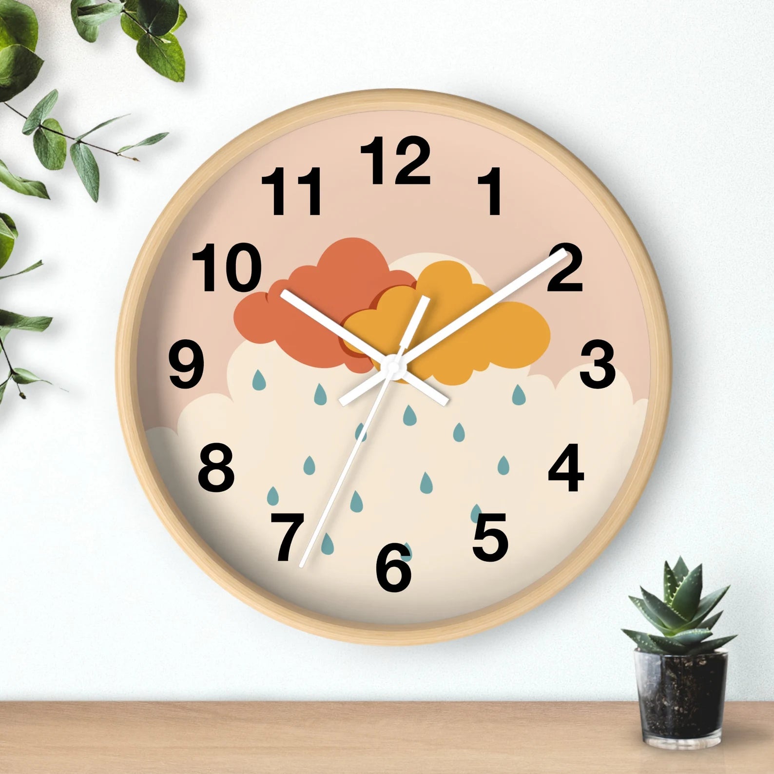 Round wooden-framed wall clock with pastel peach face featuring orange and yellow clouds and teal raindrops silent design