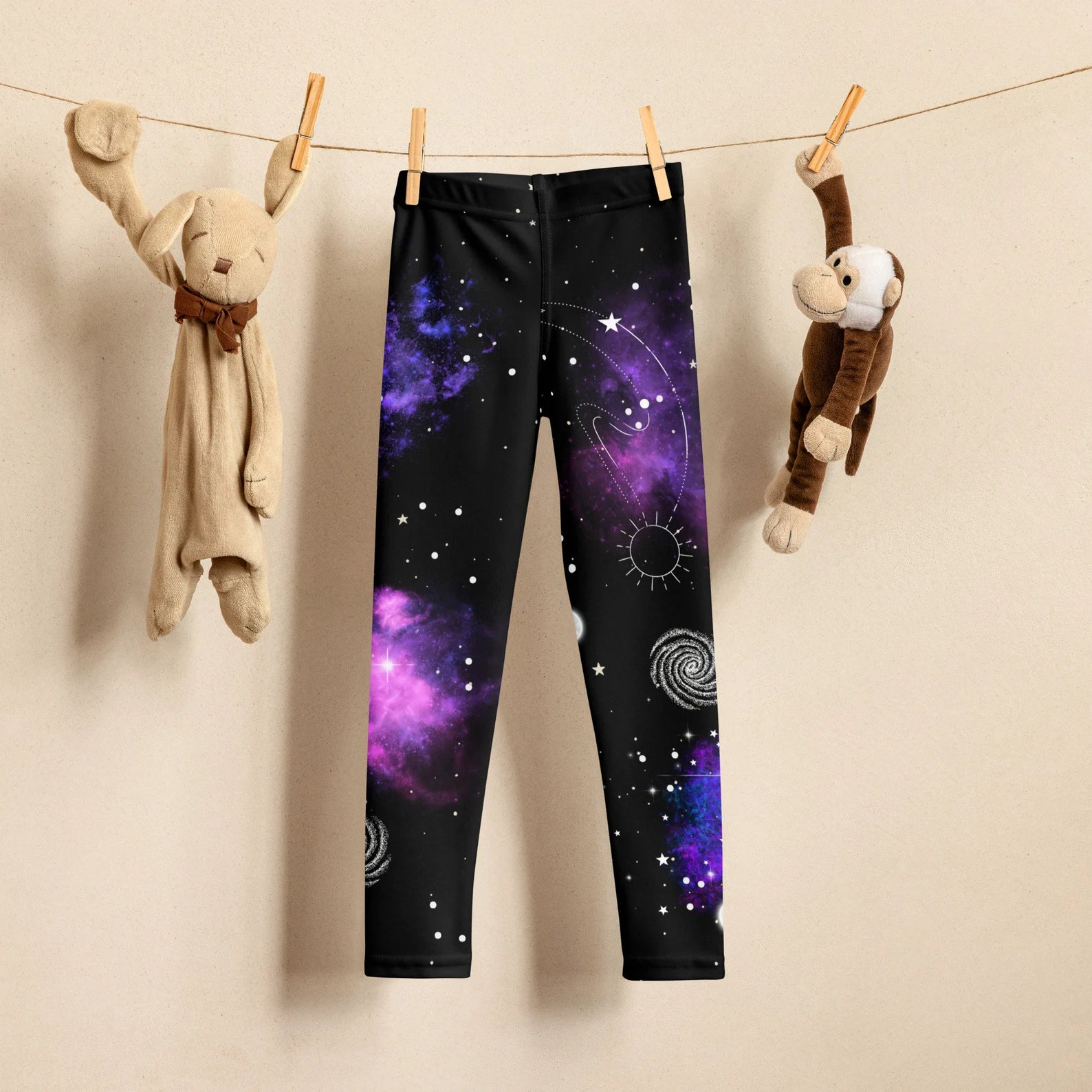 Kids nebula galaxy buttery soft black leggings with vibrant purple blue cosmic design and white celestial symbols