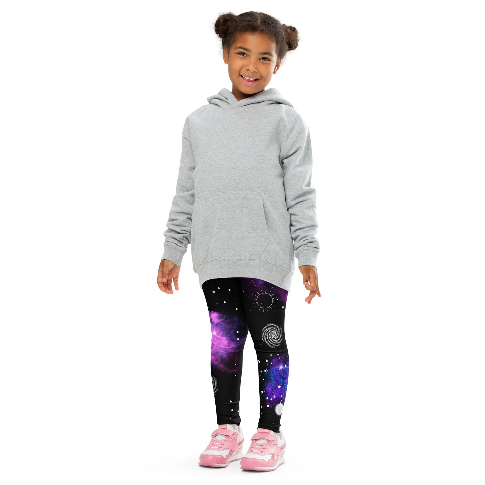Gray hooded sweatshirt with front pocket worn over kids nebula galaxy buttery soft leggings in purple nebula print
