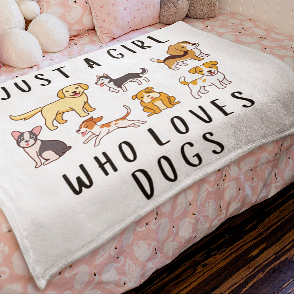 White plush girls blanket with cartoon dogs and just a girl who loves dogs text in black lettering