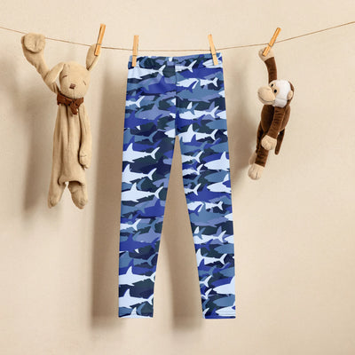 Kids blue shark buttery soft leggings hanging on a clothesline showcasing the front side design
