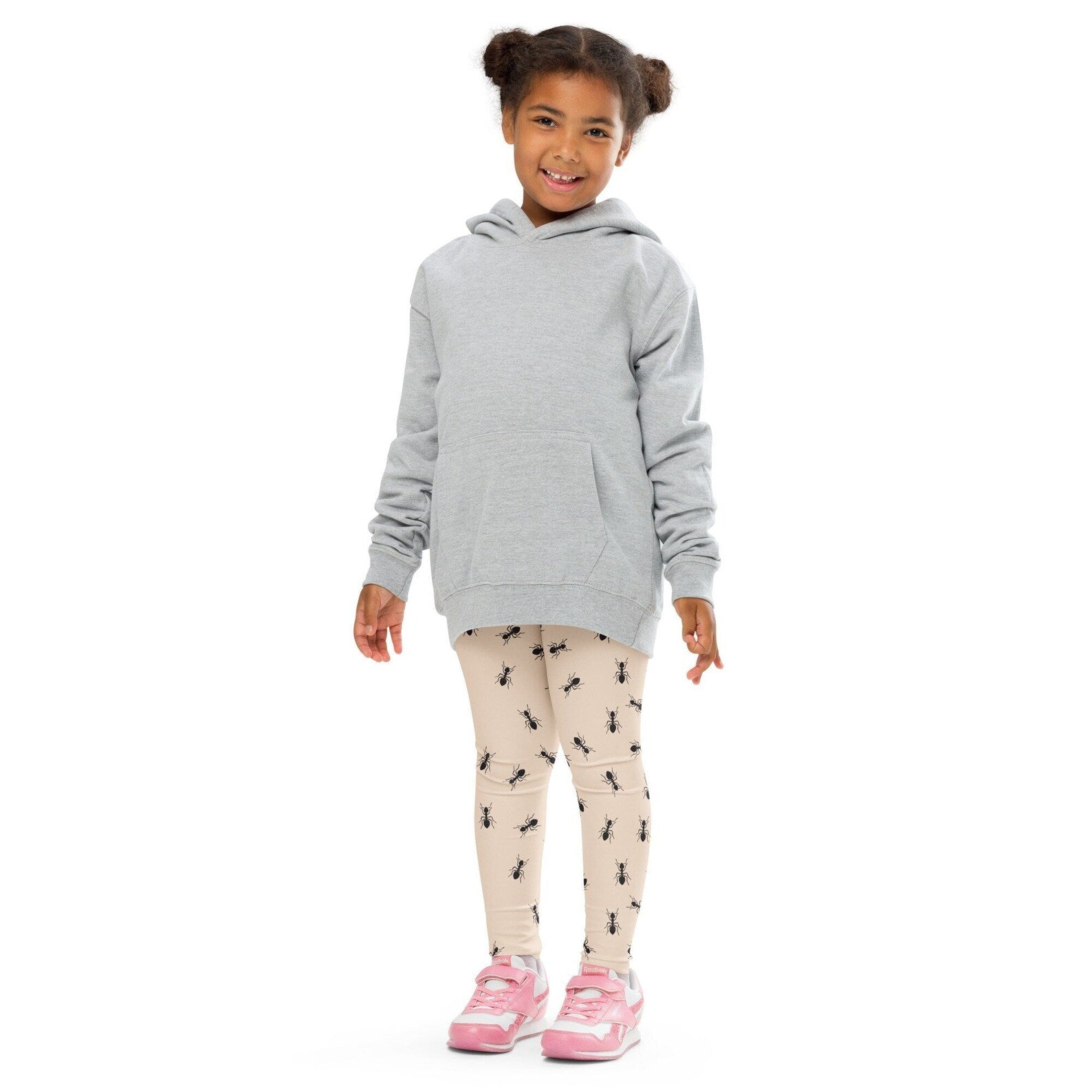 A child wearing beige kids ant buttery soft leggings with upf 50 plus paired with a light gray hooded sweatshirt