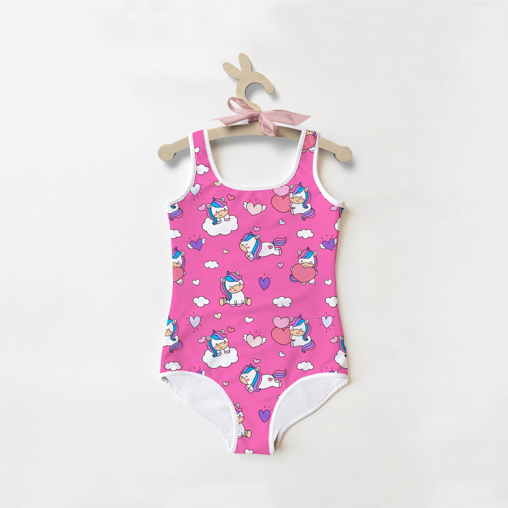 Pink girls unicorn hearts buttery soft one-piece swimsuit with white trim and playful cartoon unicorn pattern
