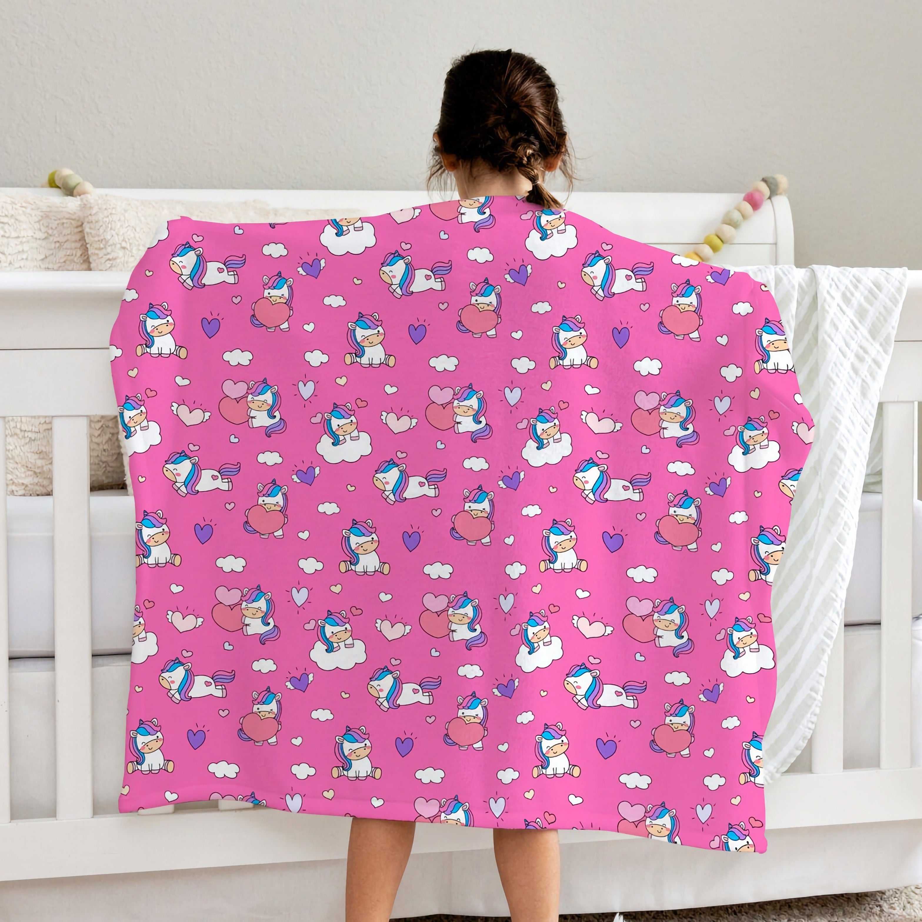 Pink girls unicorn hearts blanket with playful cartoon unicorns clouds and hearts pattern in white and purple