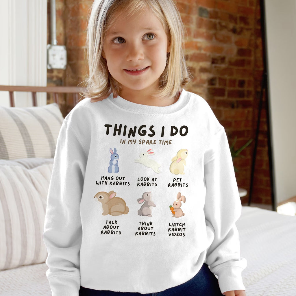 Kids white long-sleeved sweatshirt with playful rabbit graphic and things i do in my spare time text for cozy youth wear