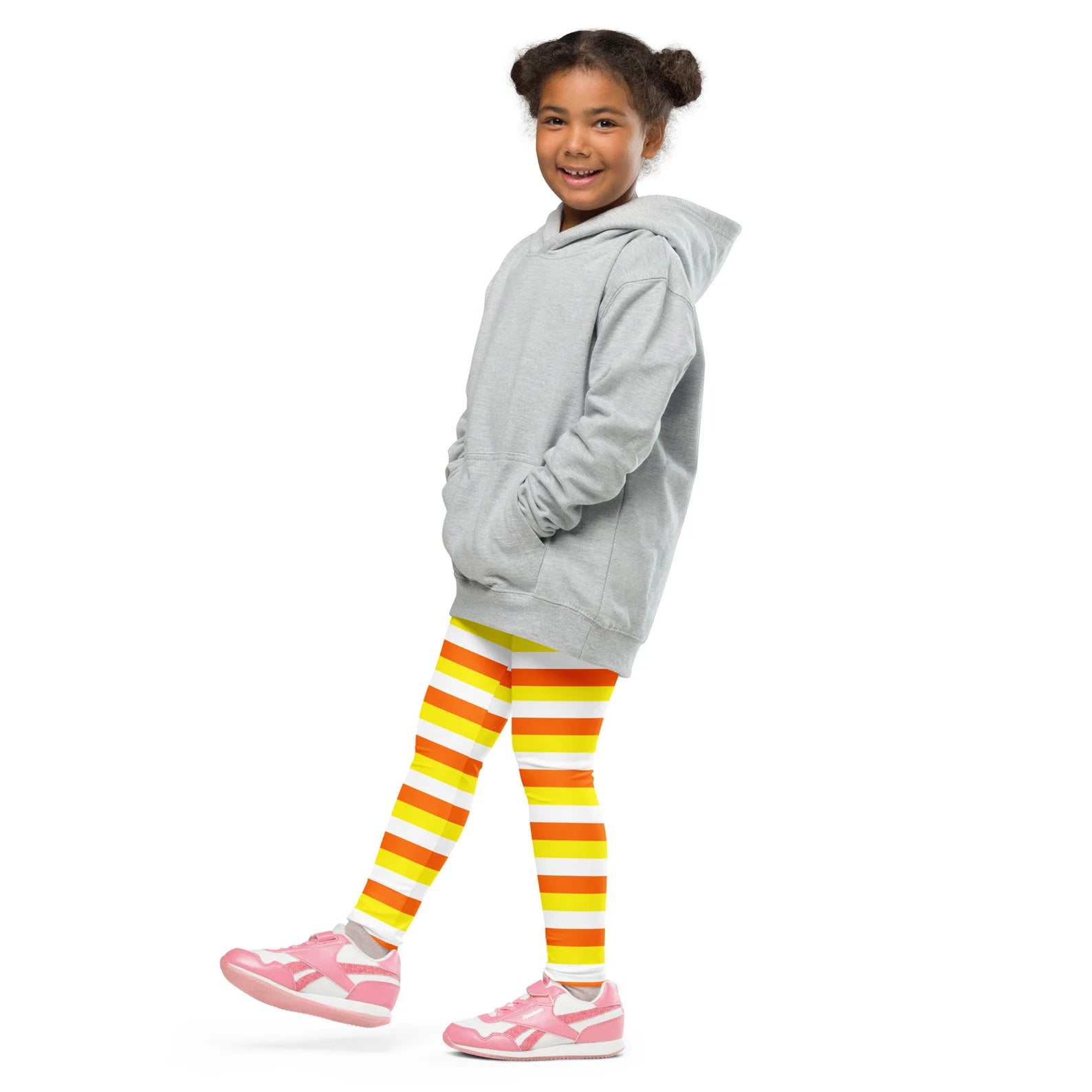 Gray hooded sweatshirt with front pockets and relaxed fit paired with kids striped halloween candy corn buttery soft leggings