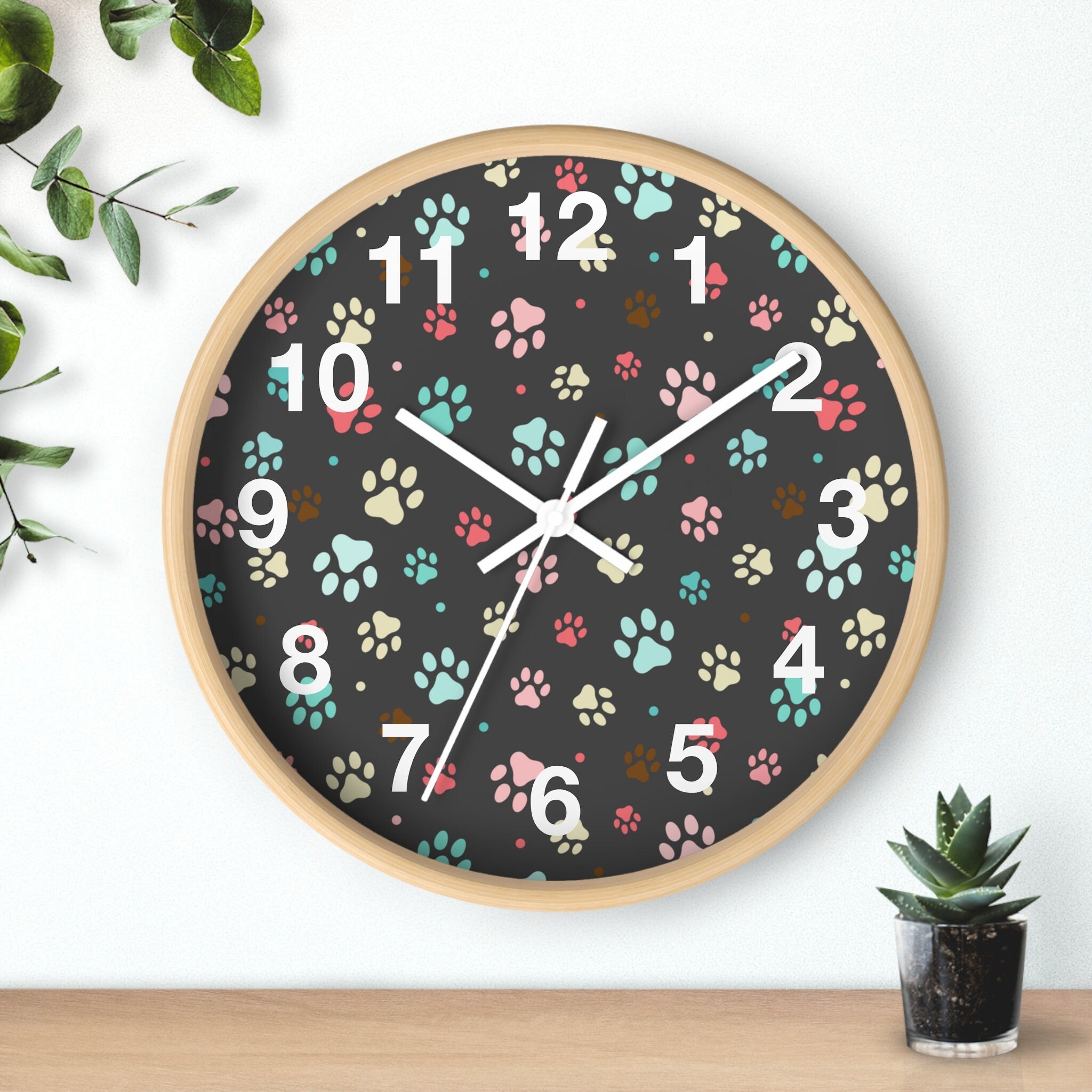 Kids colorful paw print silent wood wall clock with light wood frame black face and pink teal beige paw prints
