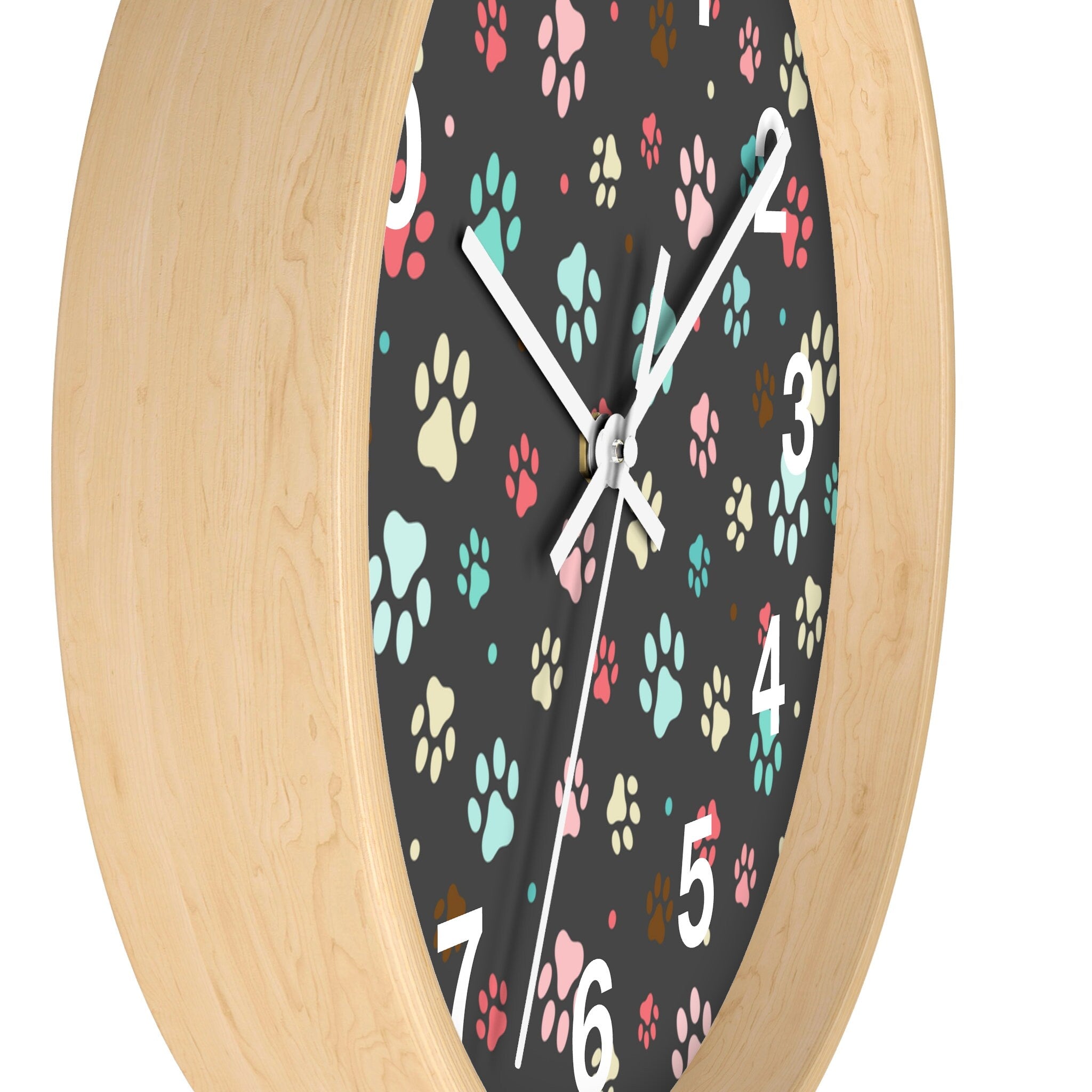 Kids colorful paw print silent wood wall clock with a round light wood frame and black face featuring colorful paw prints
