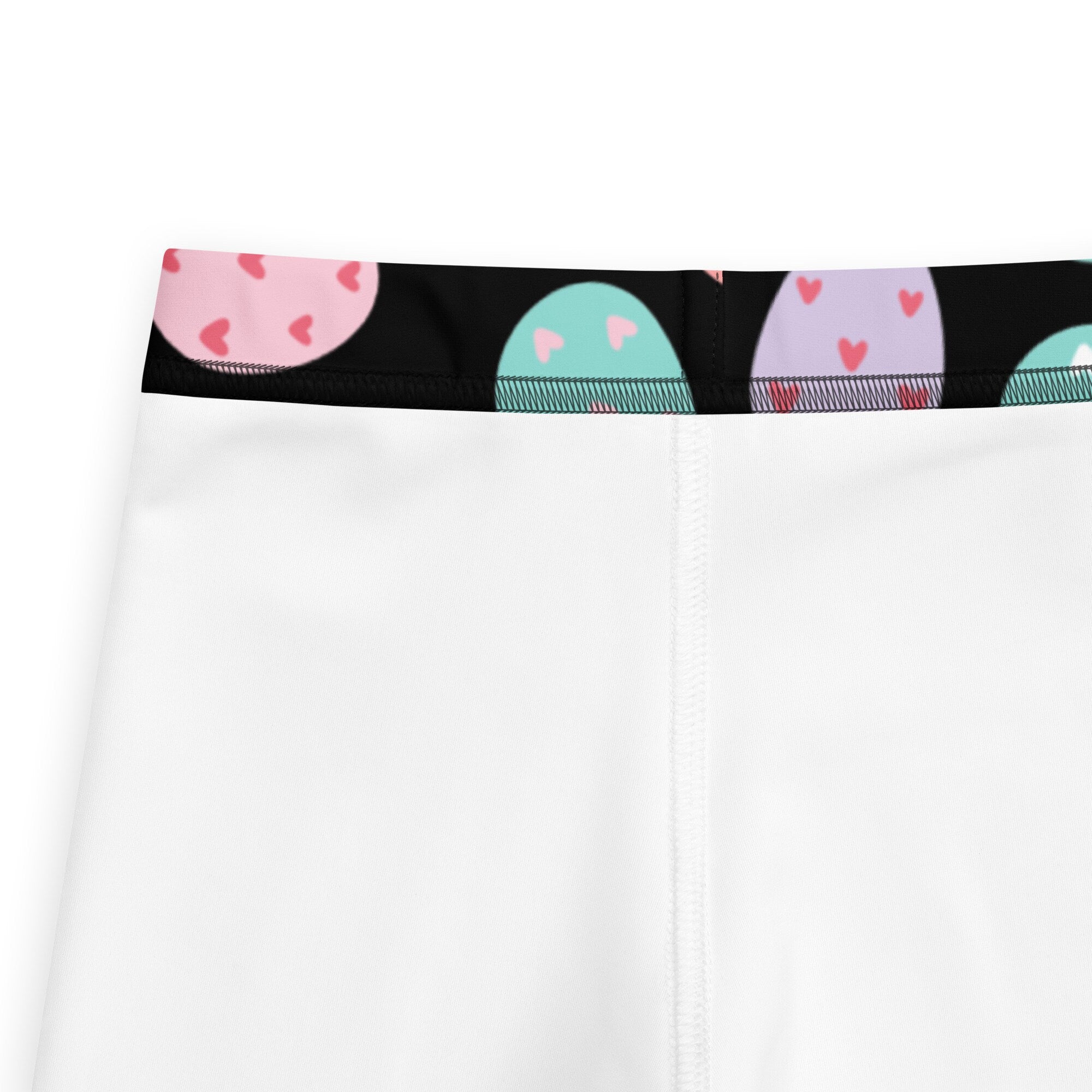 Kids colorful easter egg buttery soft leggings in white with black waistband and pastel egg patterns with pink hearts