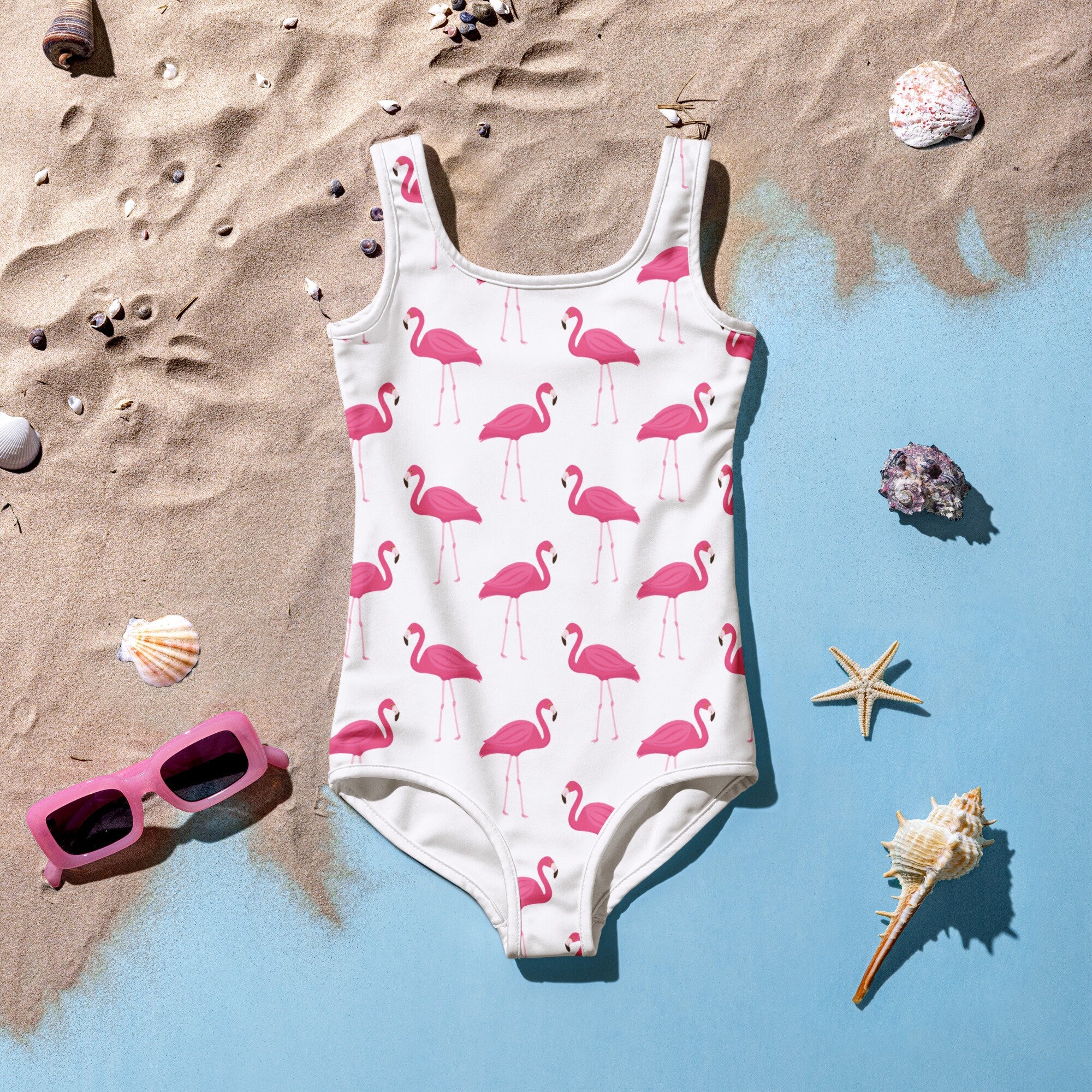 Girls pink flamingo buttery soft swimsuit in white one piece with repeating pink flamingo pattern for swimming