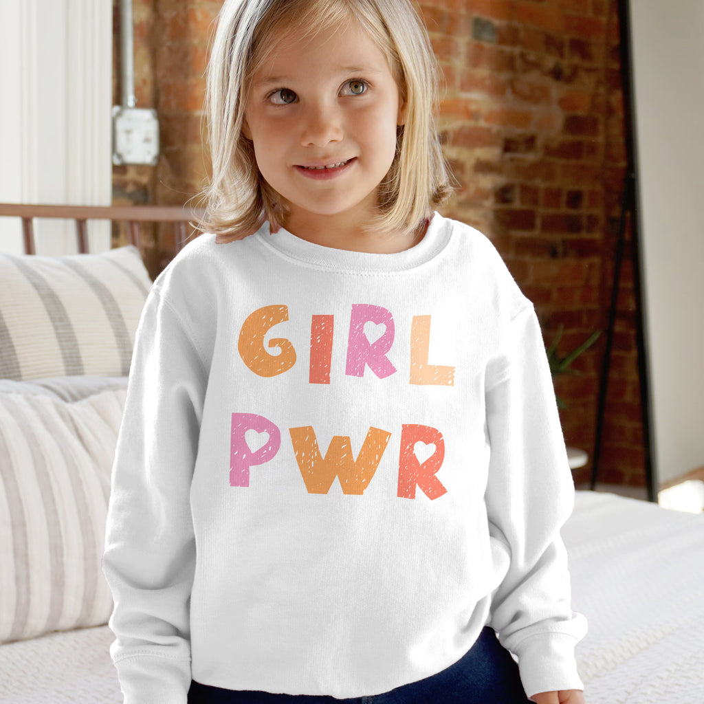 White long-sleeved kids sweatshirt with colorful textured girl pwr print in orange and pink hues