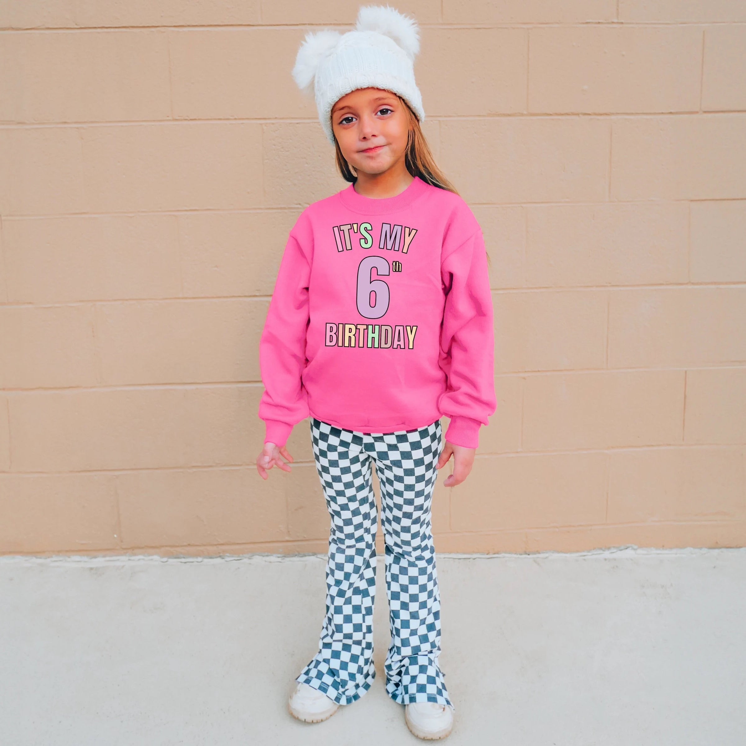 Girls custom age neon pink long-sleeved sweatshirt with its my 6th birthday multicolored print on front for birthdays