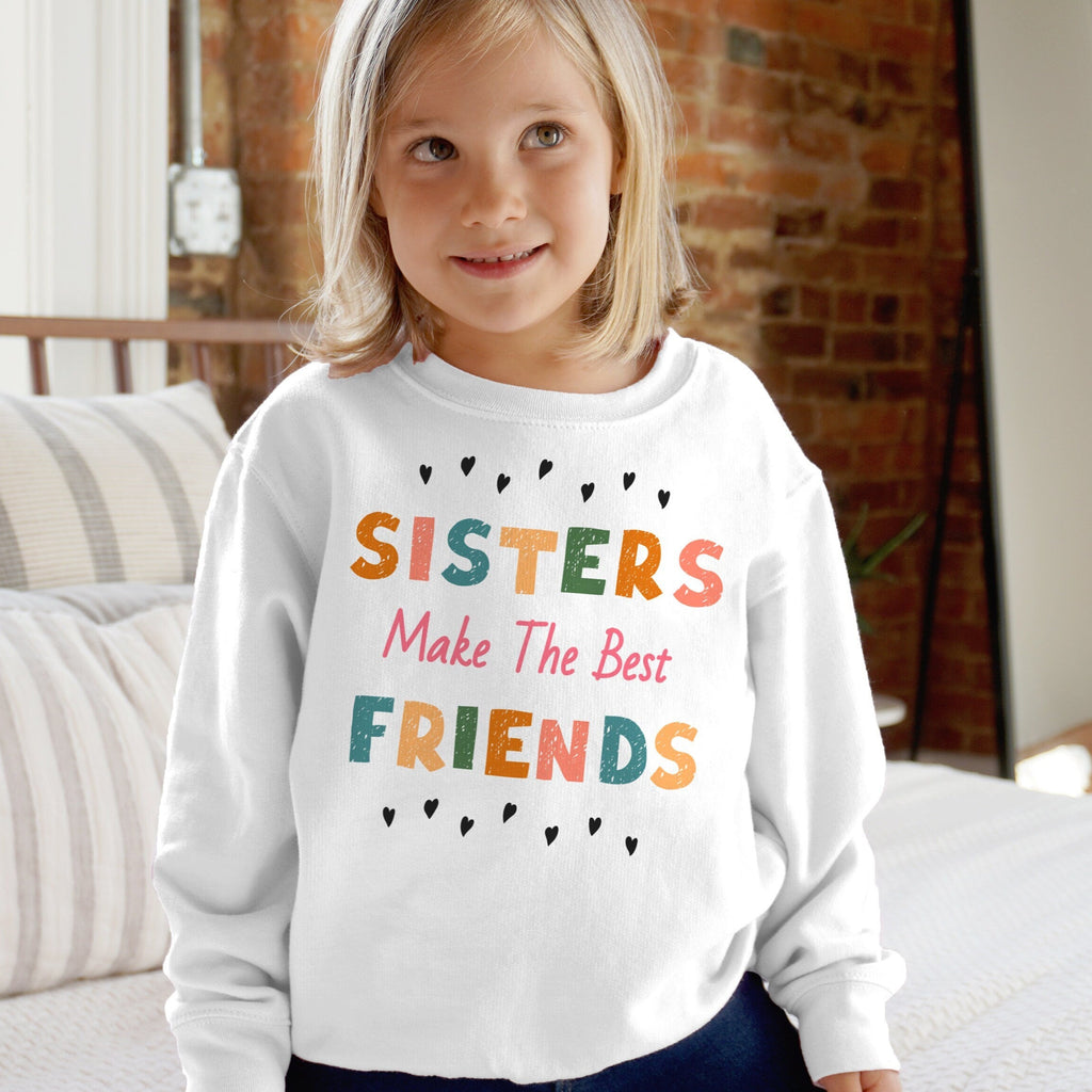 Girls white long-sleeved cozy sweatshirt with colorful sisters make the best friends graphic and black heart accents
