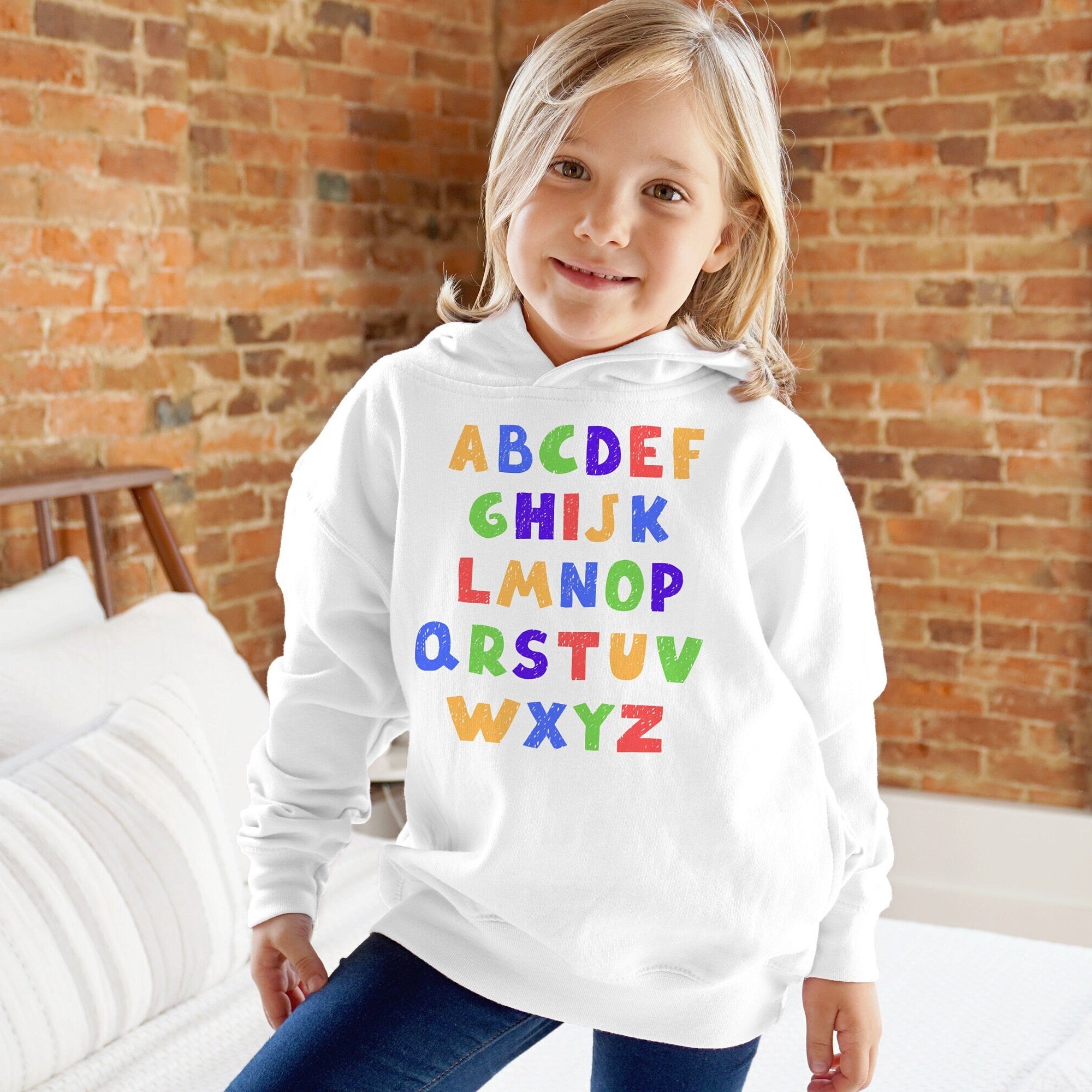 White toddler hoodie with colorful rainbow alphabet letters printed across the front for early learning