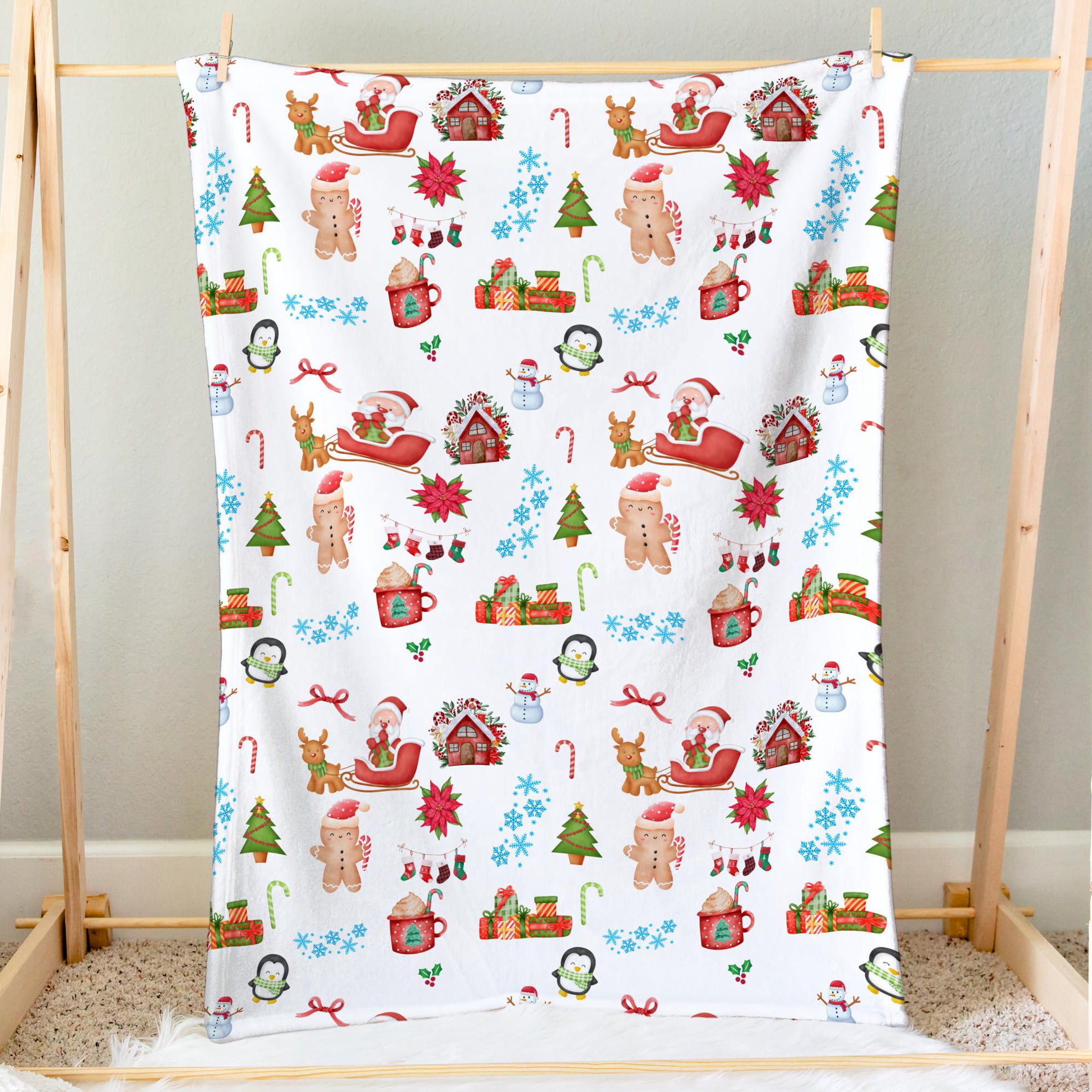 Kids christmas blanket in white soft fabric featuring festive gingerbread men santa sleigh snowmen reindeer candy canes and houses