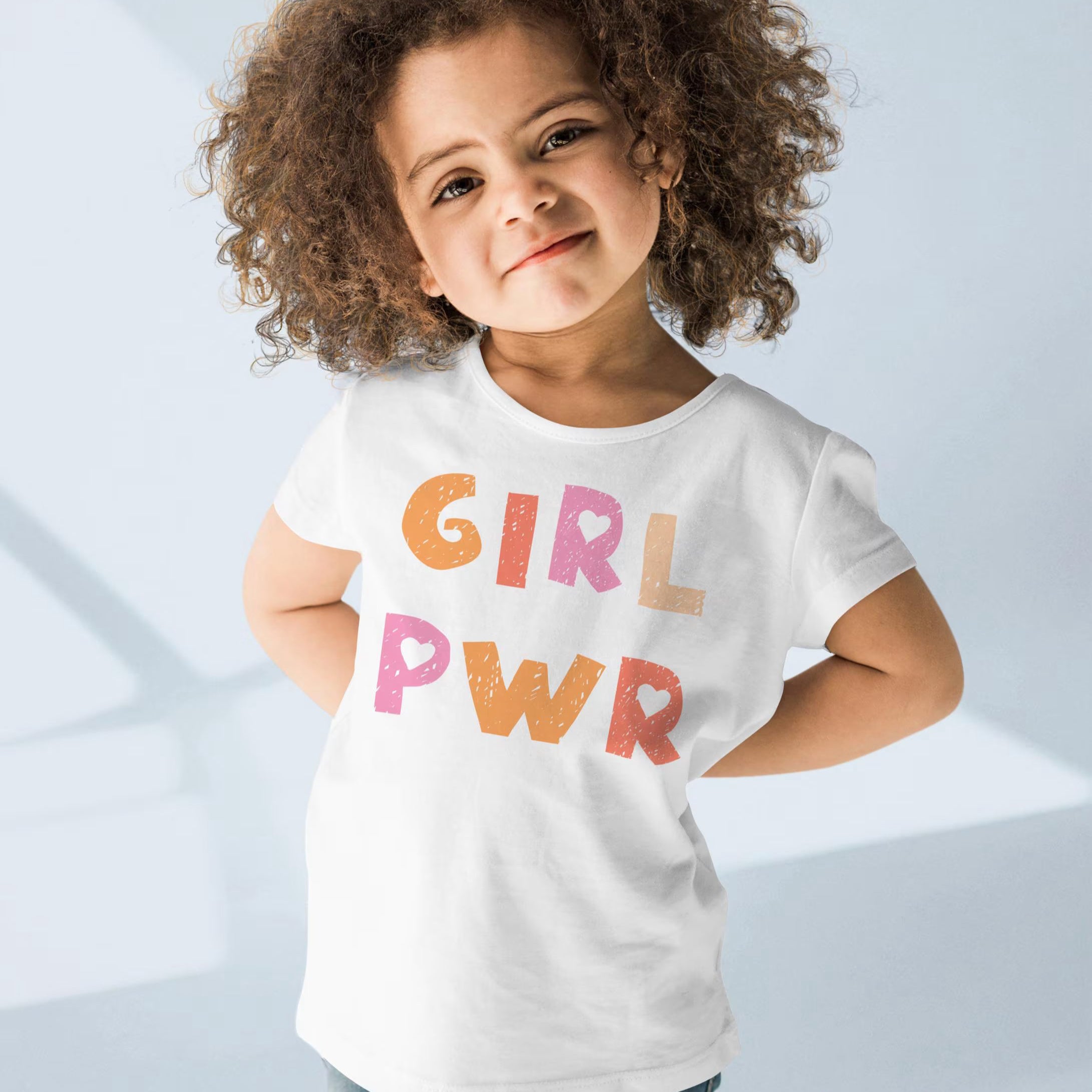 White cotton girl power kids t-shirt with colorful textured girl pwr print in orange and pink hues