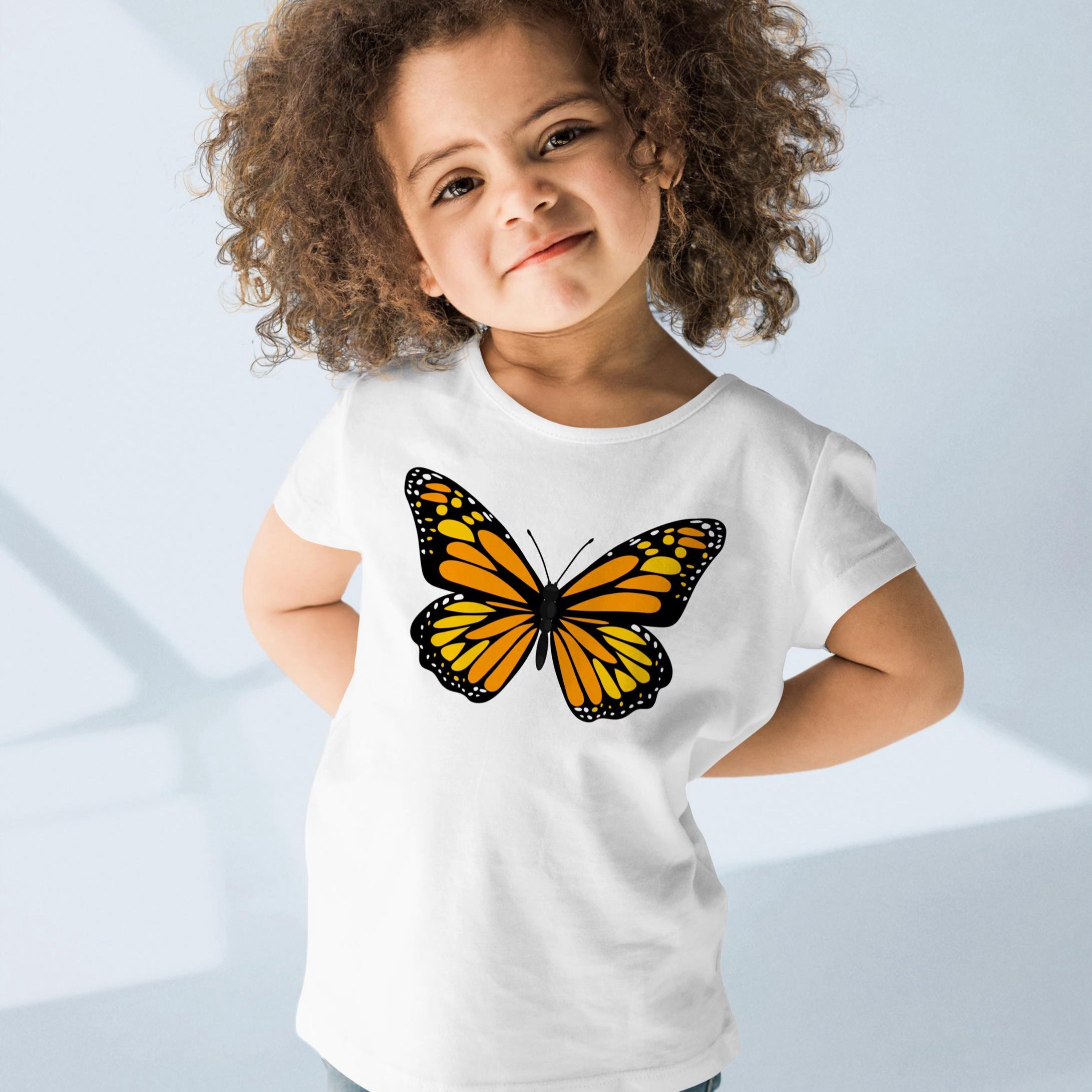 White toddler t-shirt featuring a vibrant orange and black monarch butterfly graphic for kids summer wear