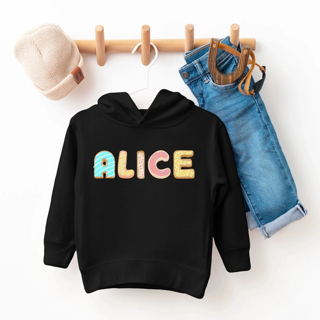 Black kids custom name cookie hoodie with colorful donut shaped alice print on chest, soft cotton material