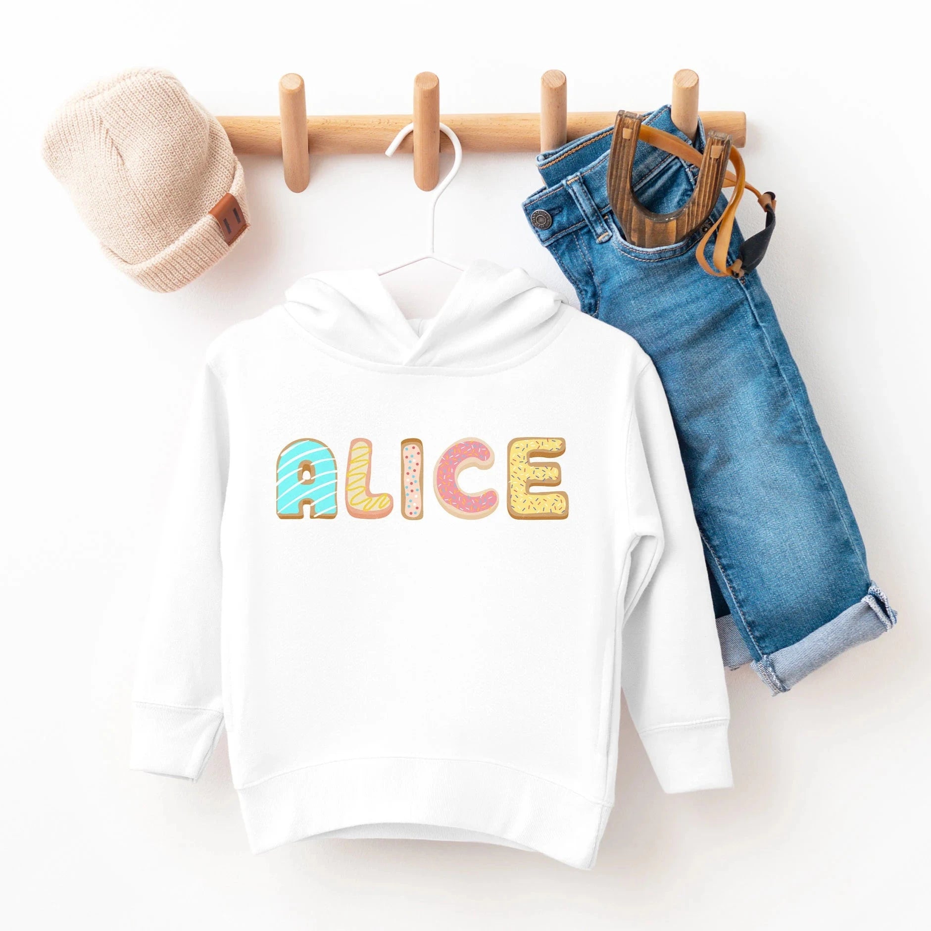 White kids custom name cookie hoodie with colorful donut shaped letters spelling alice on the chest