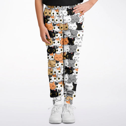 Girls cat face jogger pants in white featuring a playful cartoon cat pattern in black orange and gray
