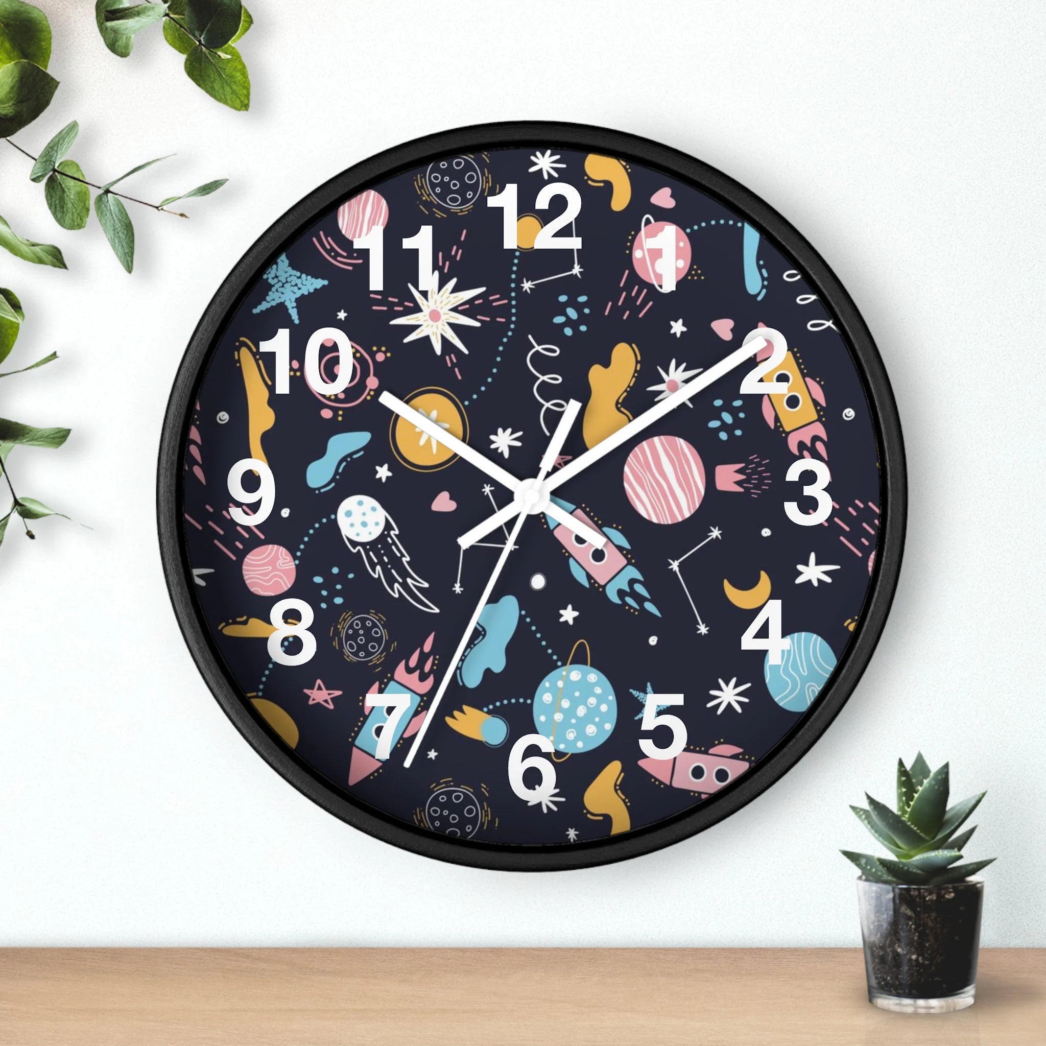 Kids outer space silent wood wall clock with black frame dark navy face and colorful pastel cartoon planets and rockets