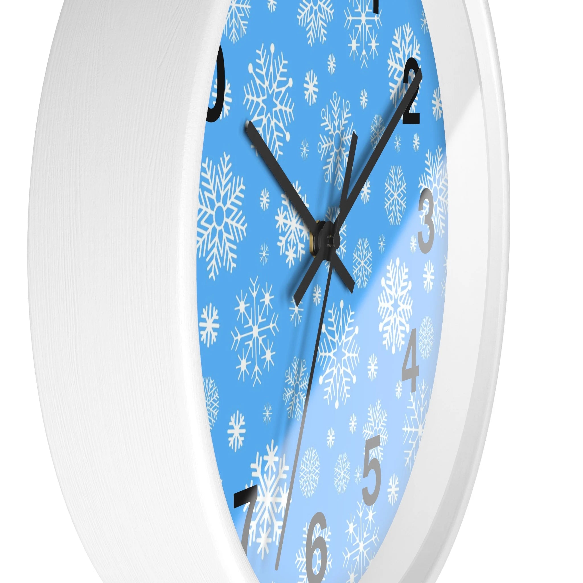 Snowflakes silent wood wall clock with white frame light blue face and intricate white snowflake patterns