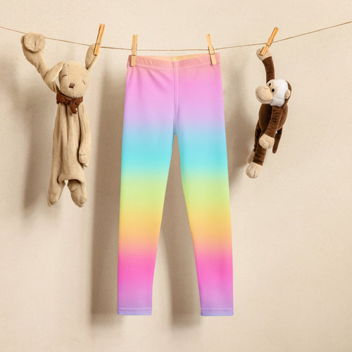 Girls bright rainbow buttery soft leggings with smooth stretchy fabric hanging on a clothesline
