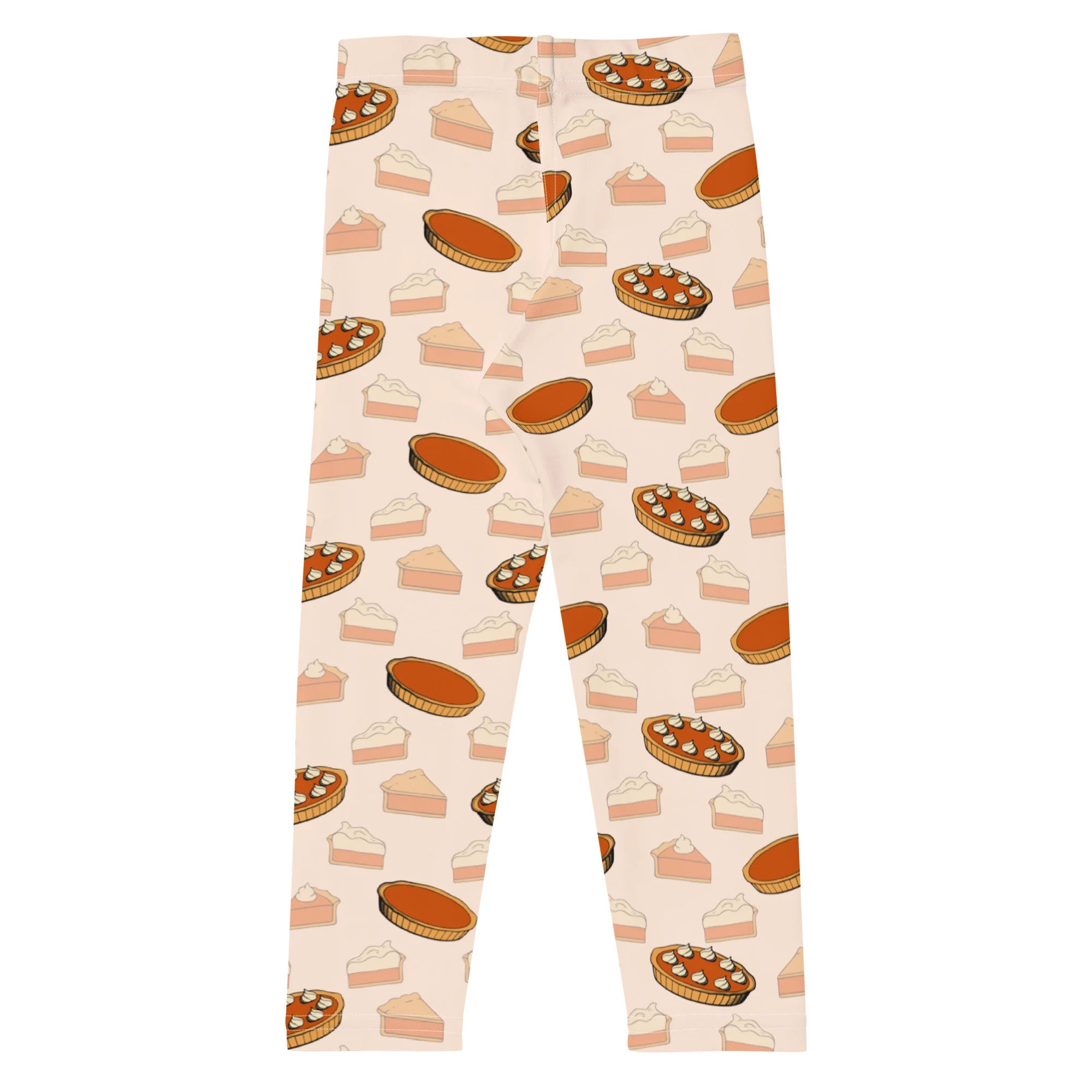 Kids pumpkin pie leggings in cream featuring playful illustrated pumpkin pies and slices in warm orange brown and beige tones