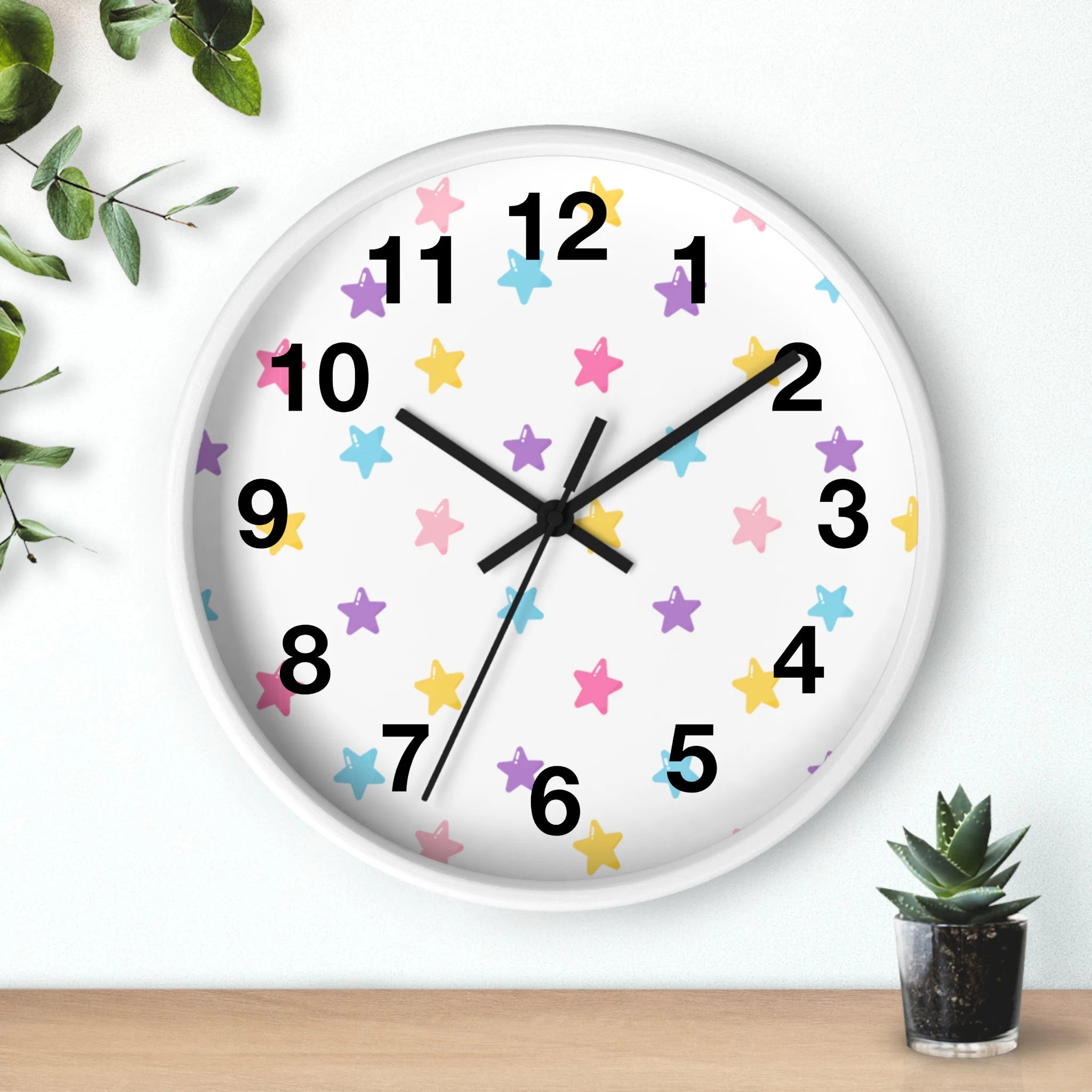 Kids colorful stars silent wood wall clock with a white face and pastel pink yellow and purple stars design